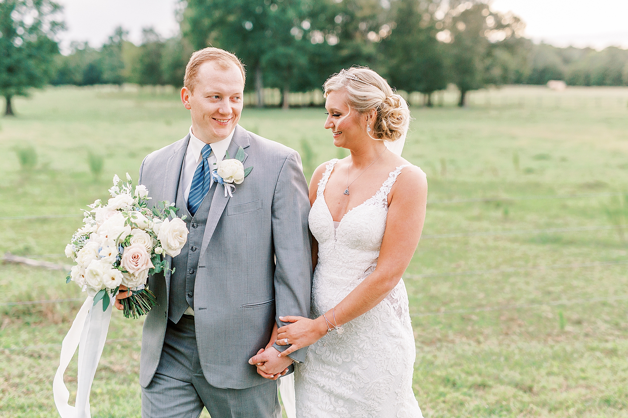 newlyweds walk together during sunset