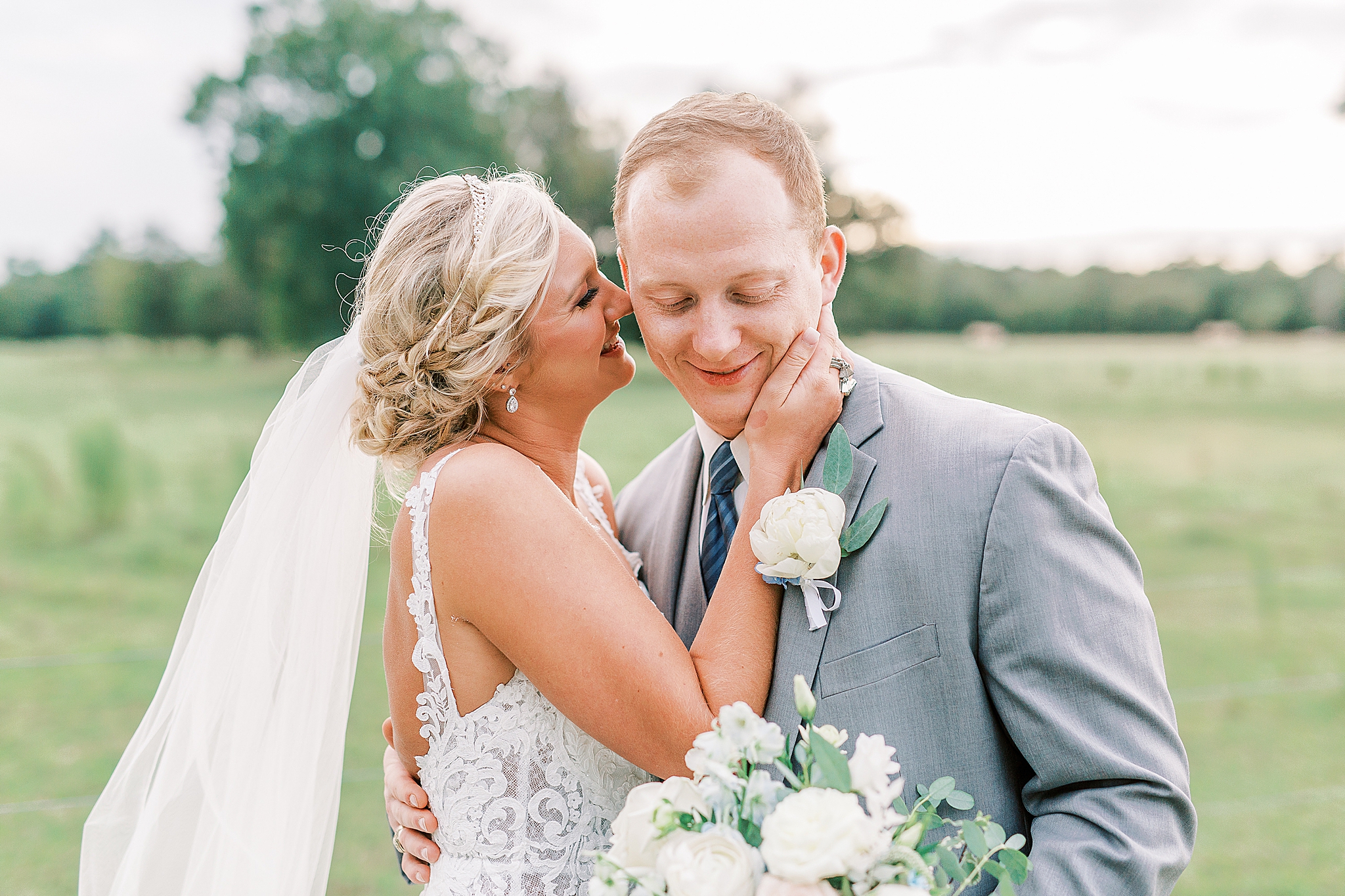 bride kisses groom on the cheek during NC wedding photos