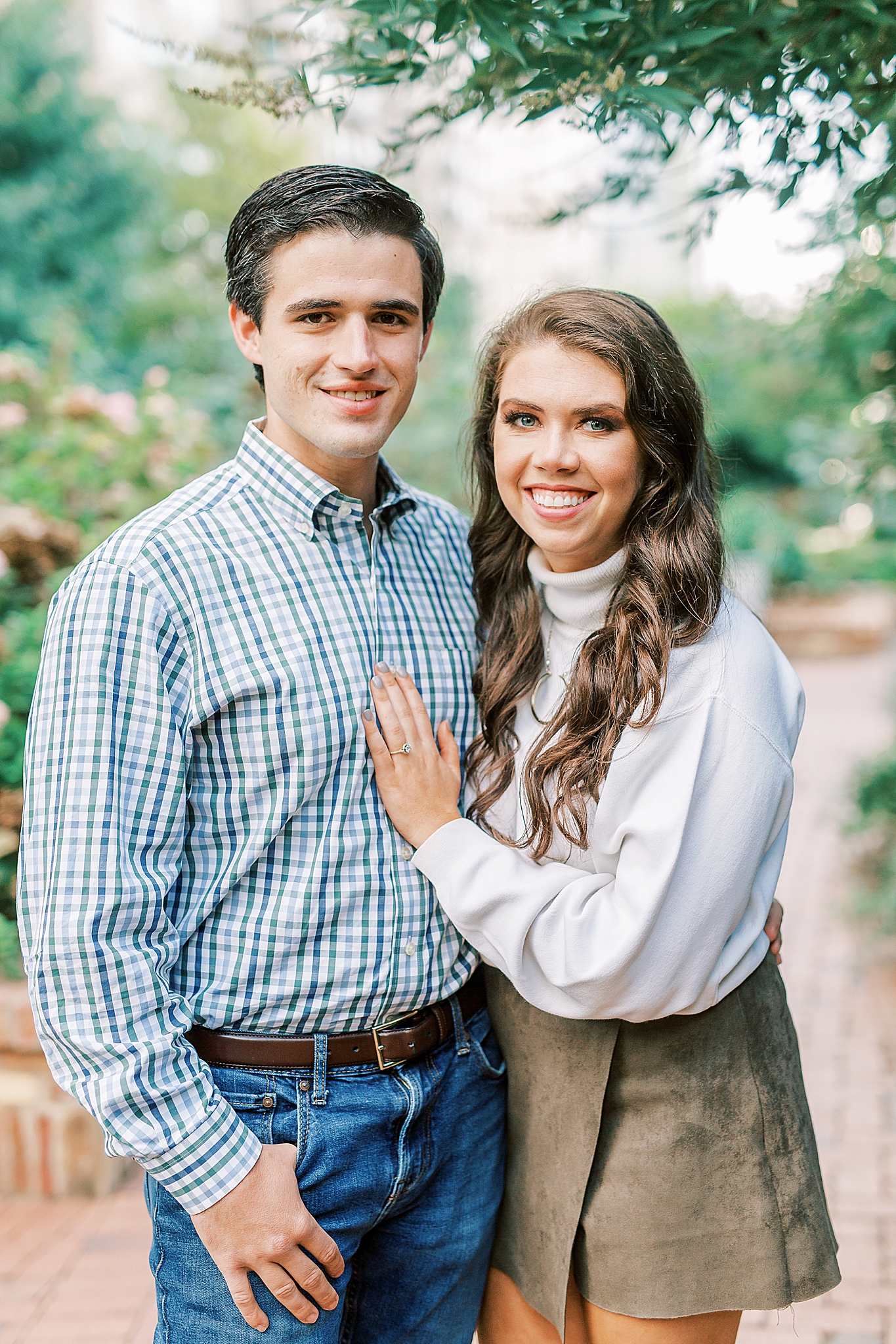engaged couple stands together in Romare Bearden Park
