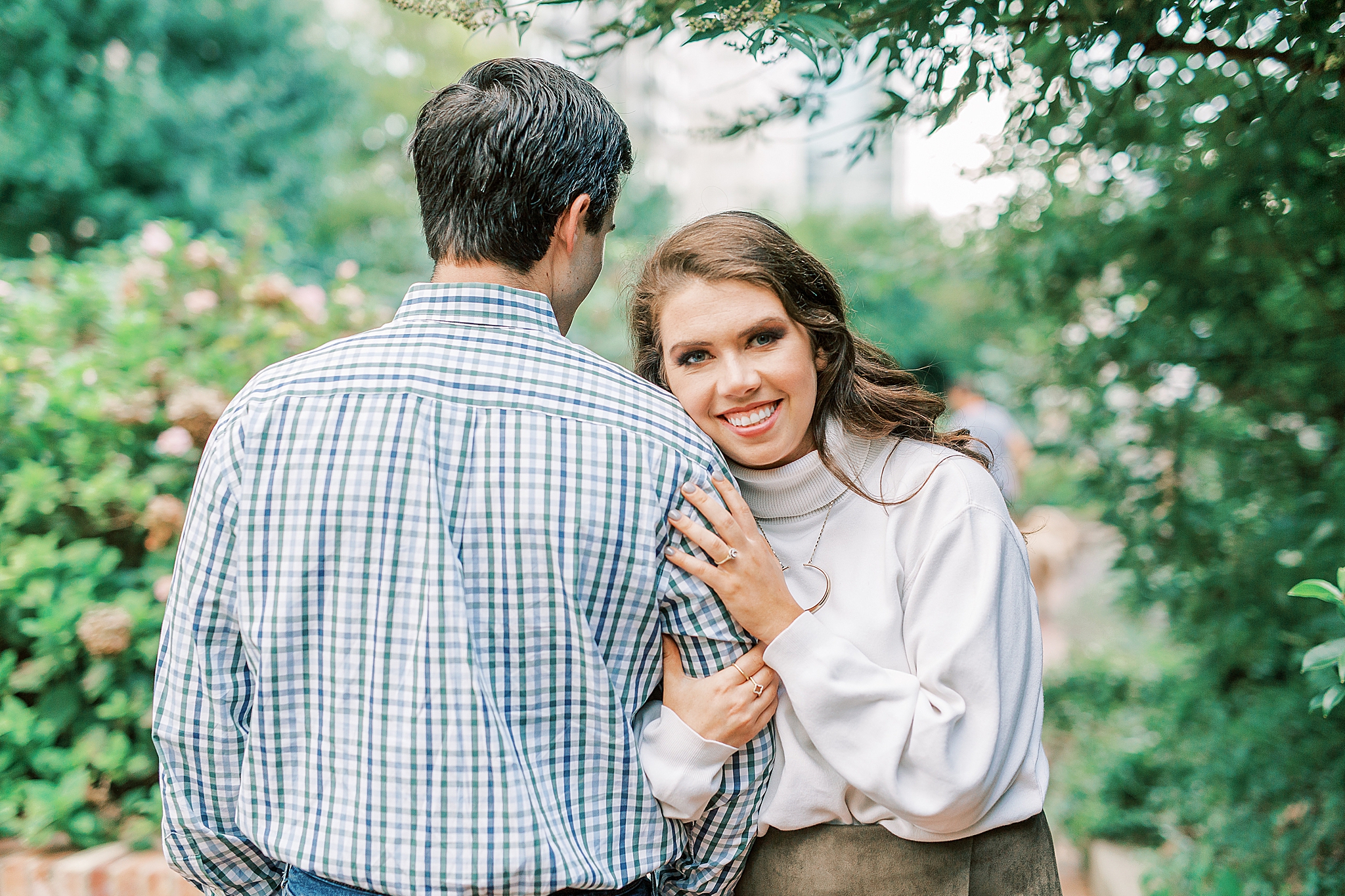 bride and groom pose in gardens at Romare Bearden Park