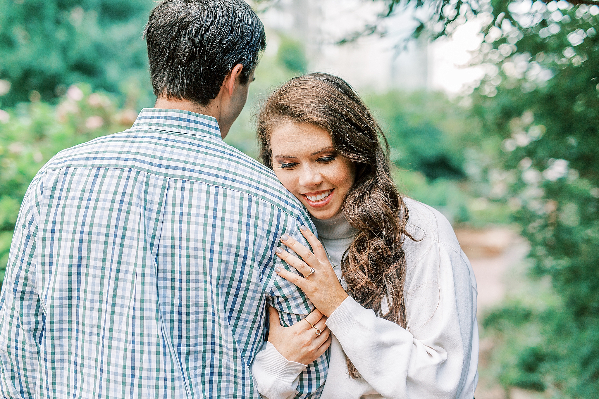 bride leans against groom's shoulder in Romare Bearden Park