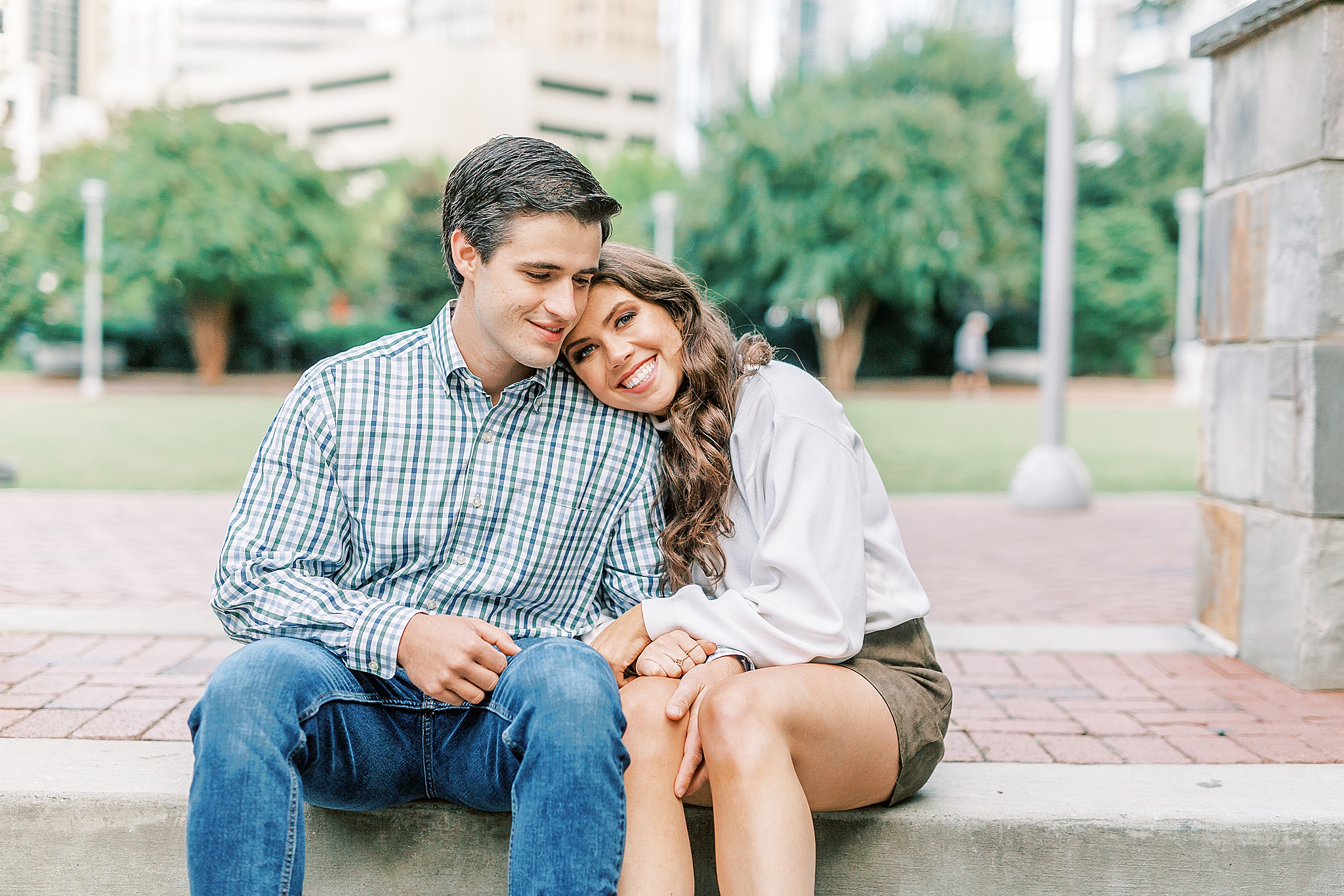couple poses on steps in Charlotte NC park