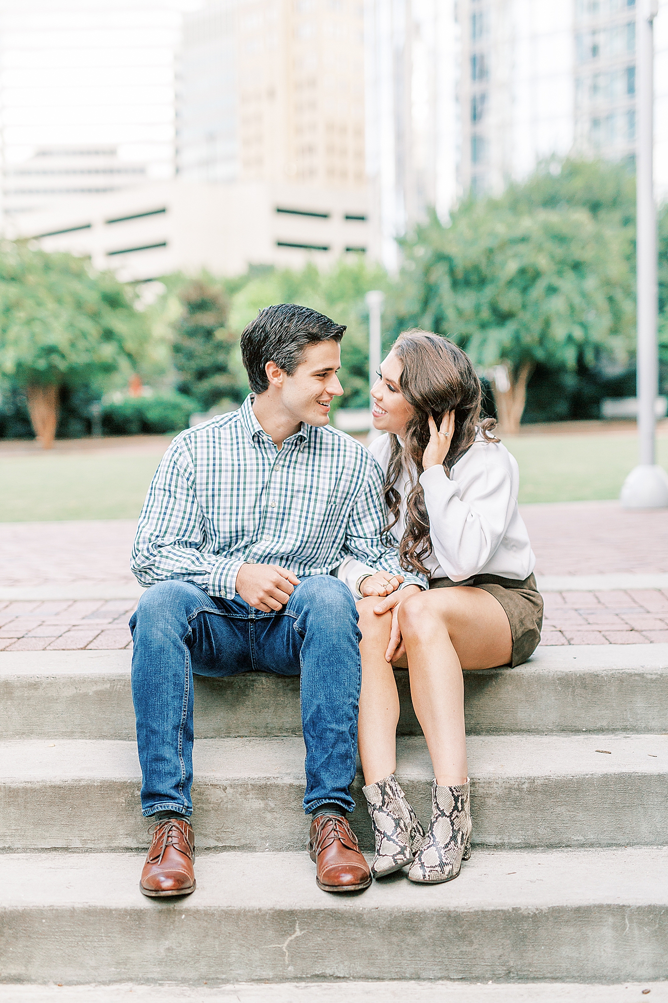 bride and groom talk while sitting on steps