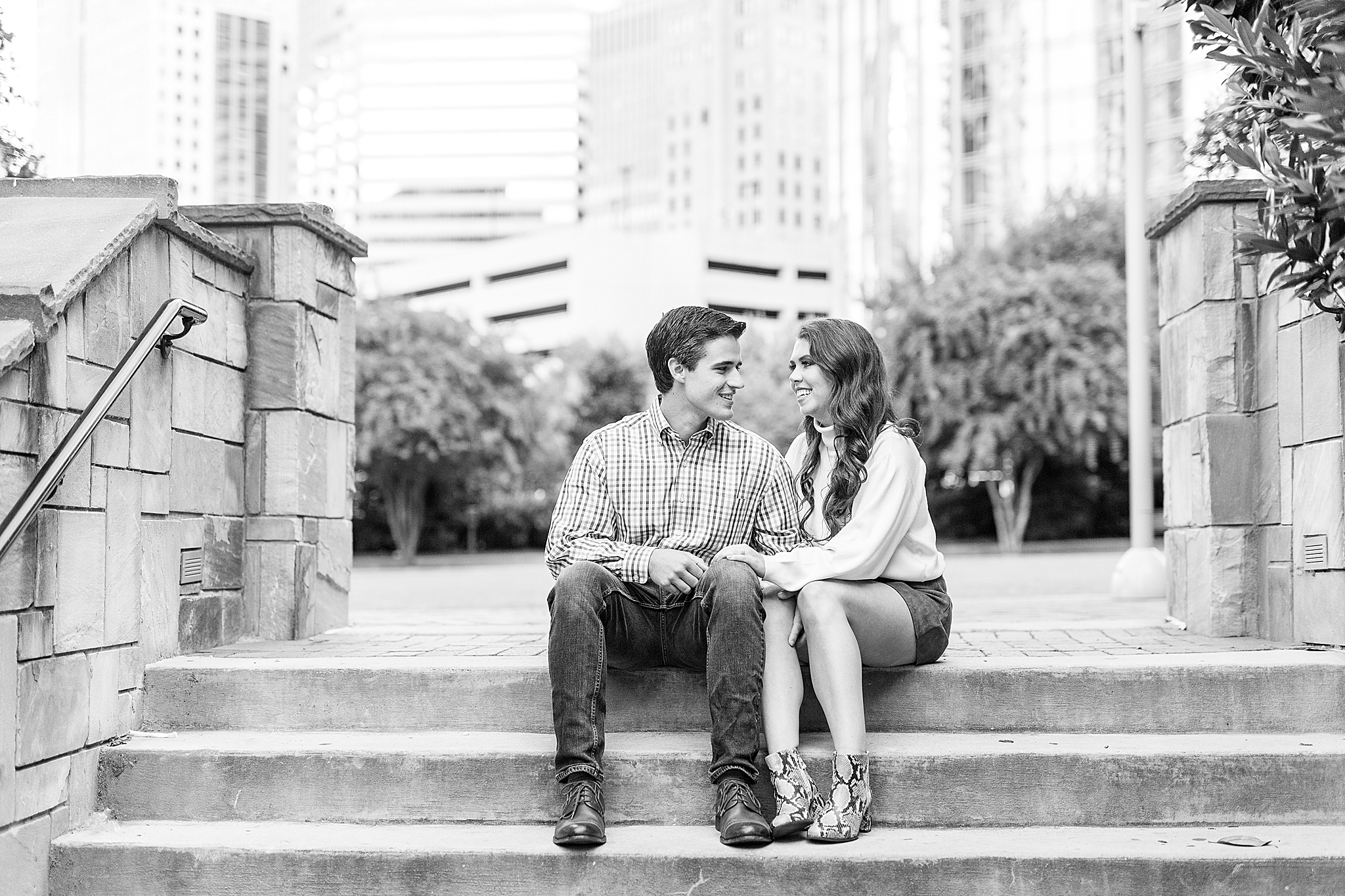 bride and groom sit on steps at Romare Bearden Park