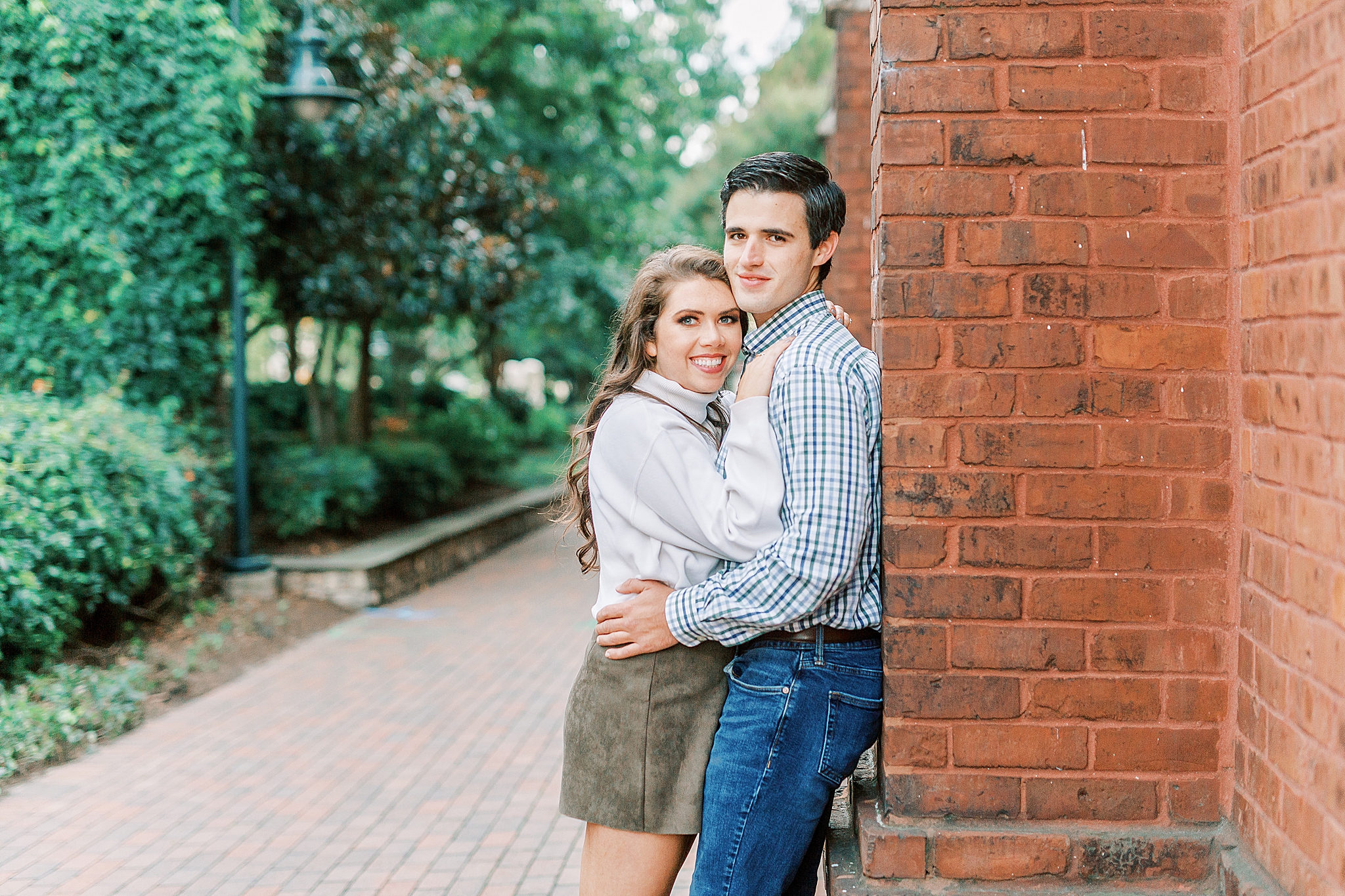 Charlotte NC engagement photos against brick wall