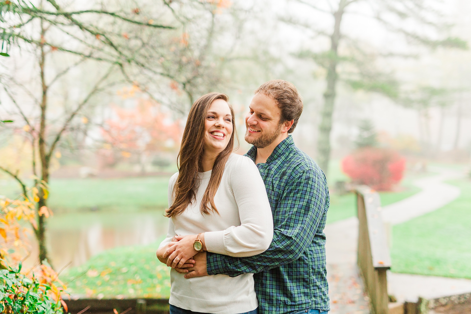 groom hugs bride from behind during NC engagement session