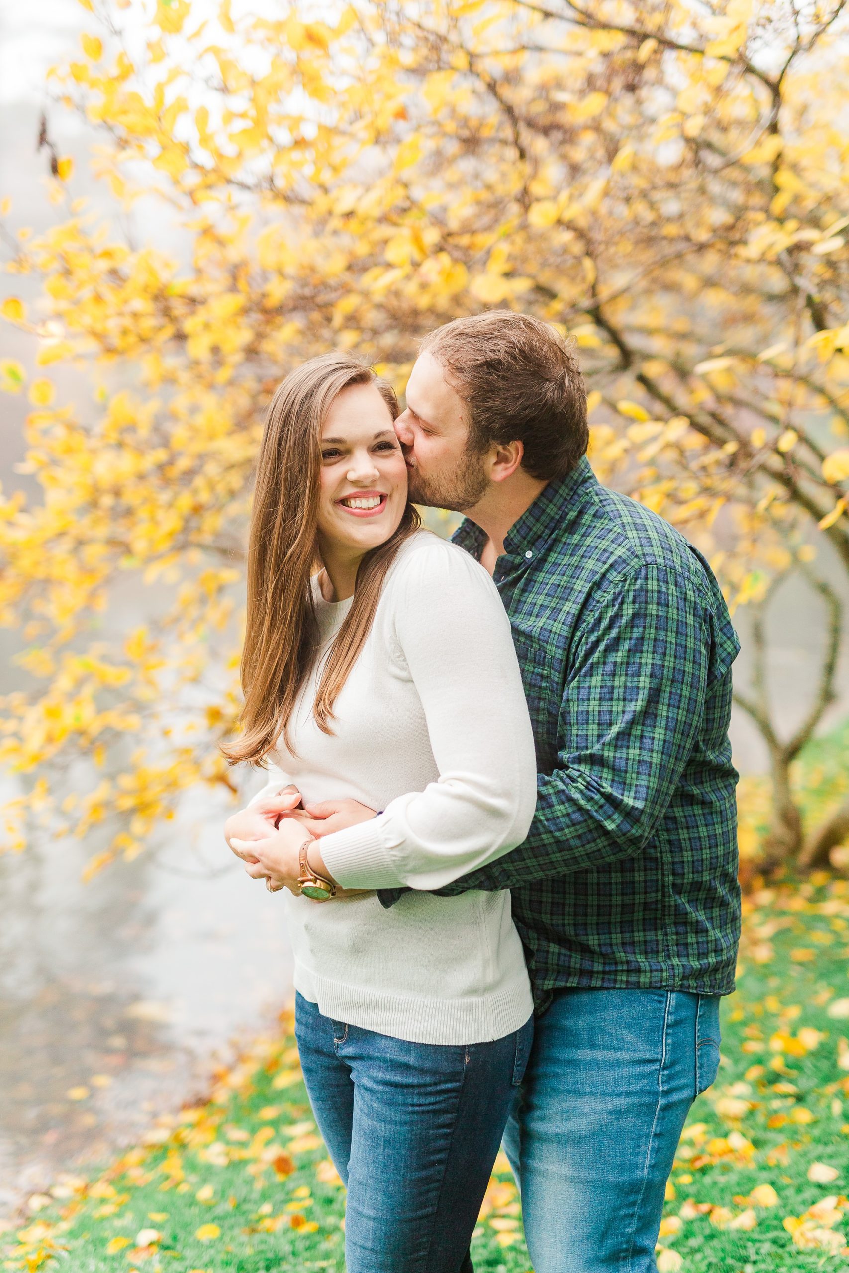 groom kisses bride's temple during NC engagement photos