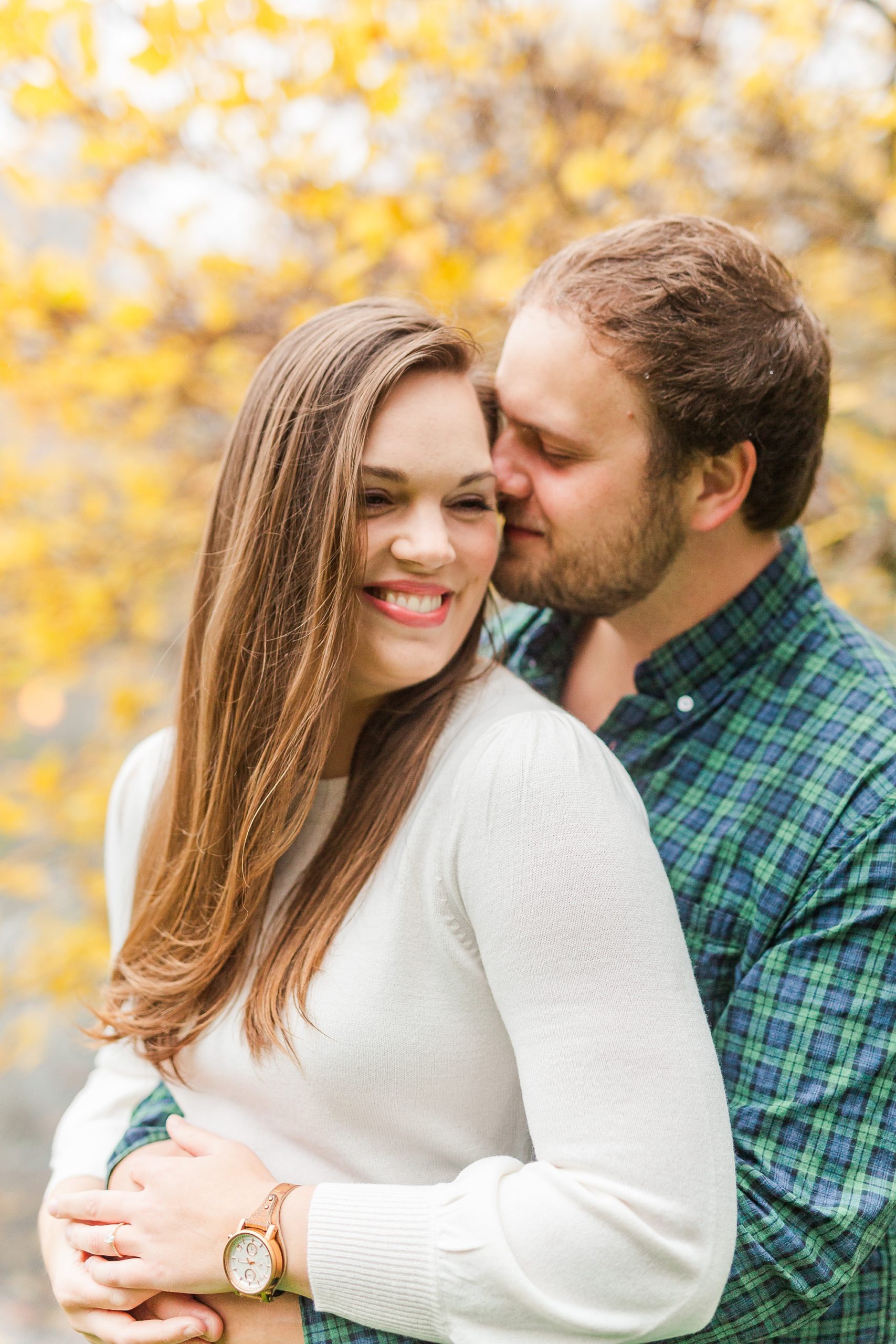 groom kisses bride's temple