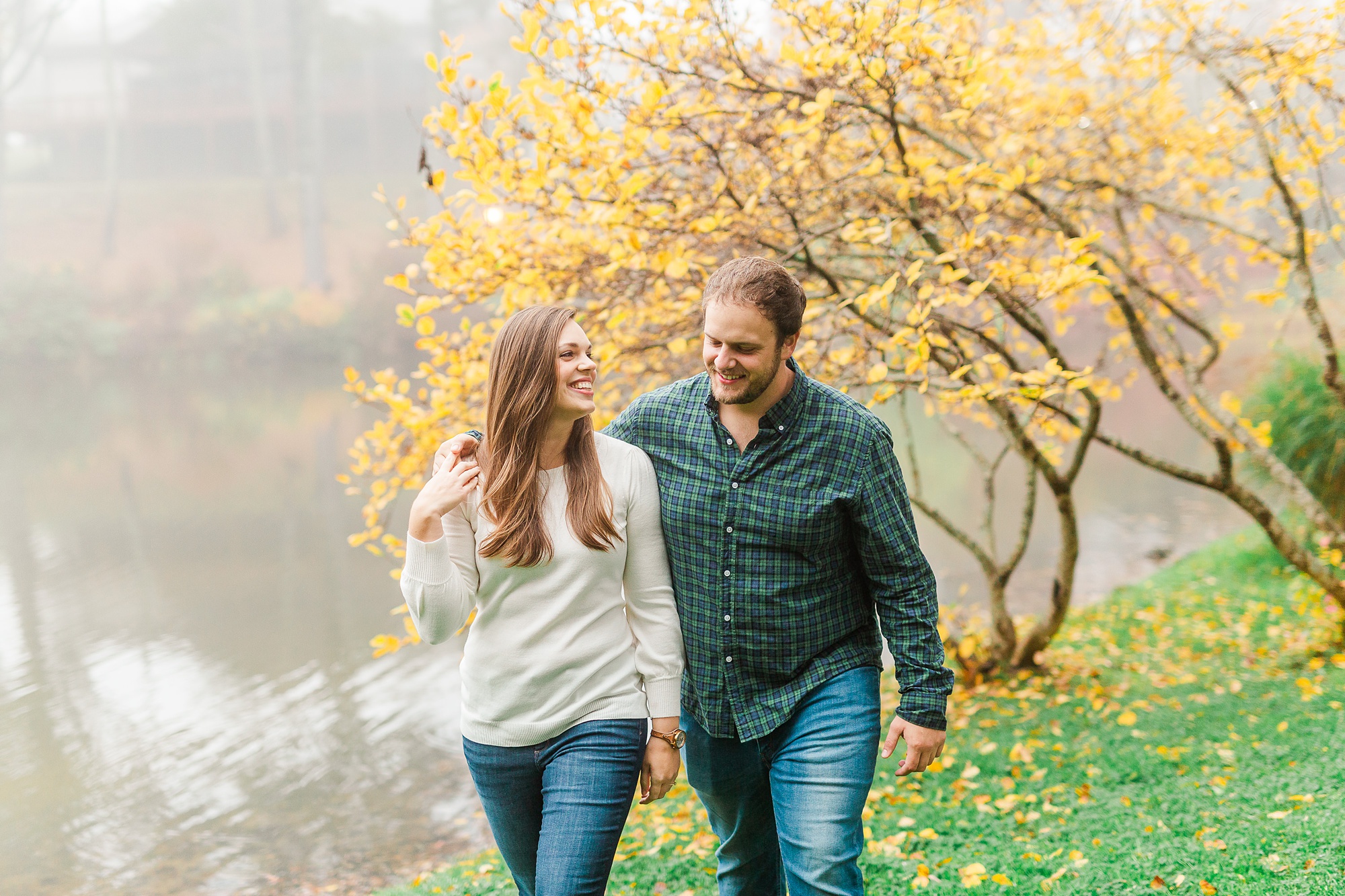 couple walks along lake in Blowing Rock NC