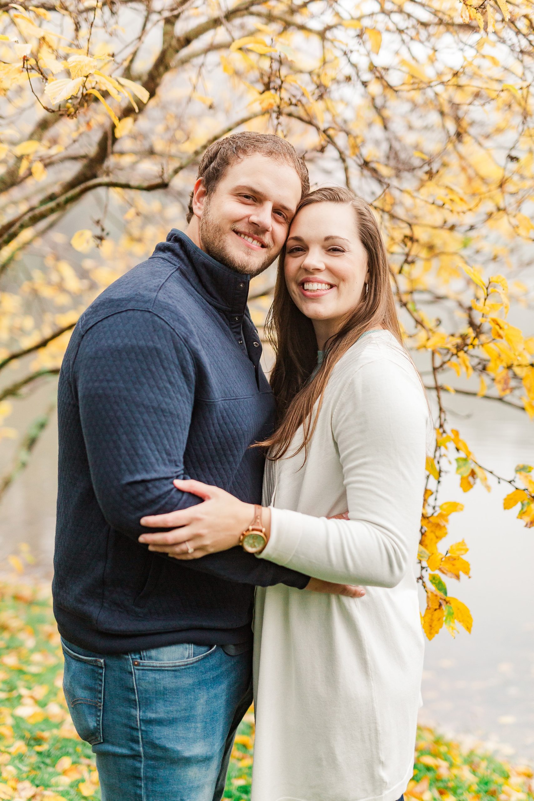 bride and groom pose in front of yellow tree