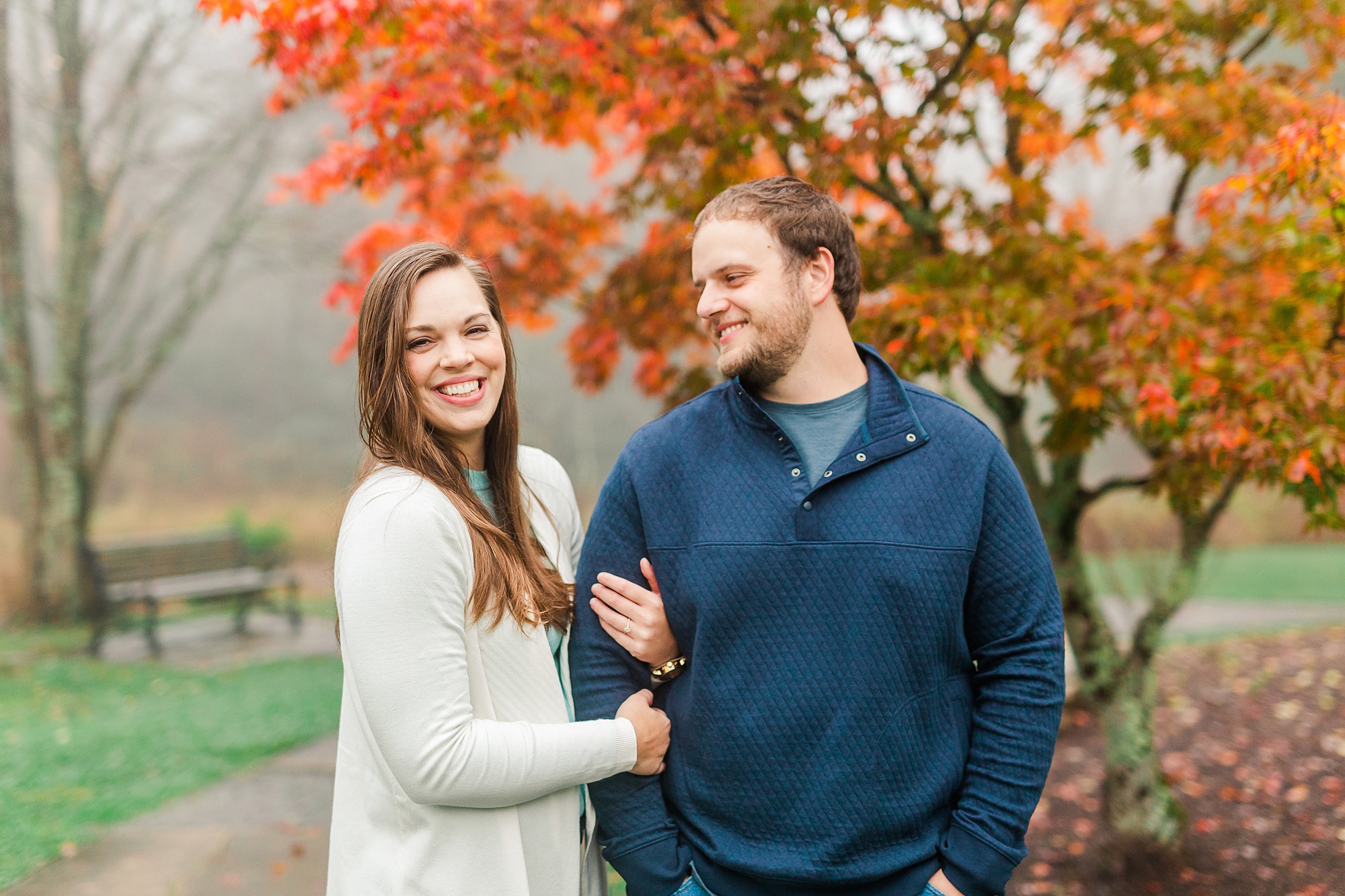 bride holds onto groom during NC engagement photos