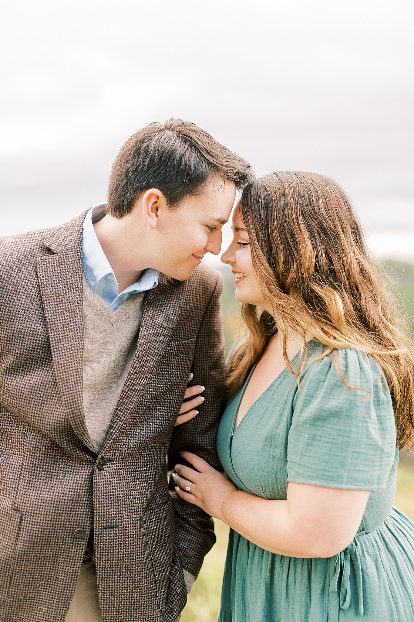 engaged couple stands nose to nose in Boone NC
