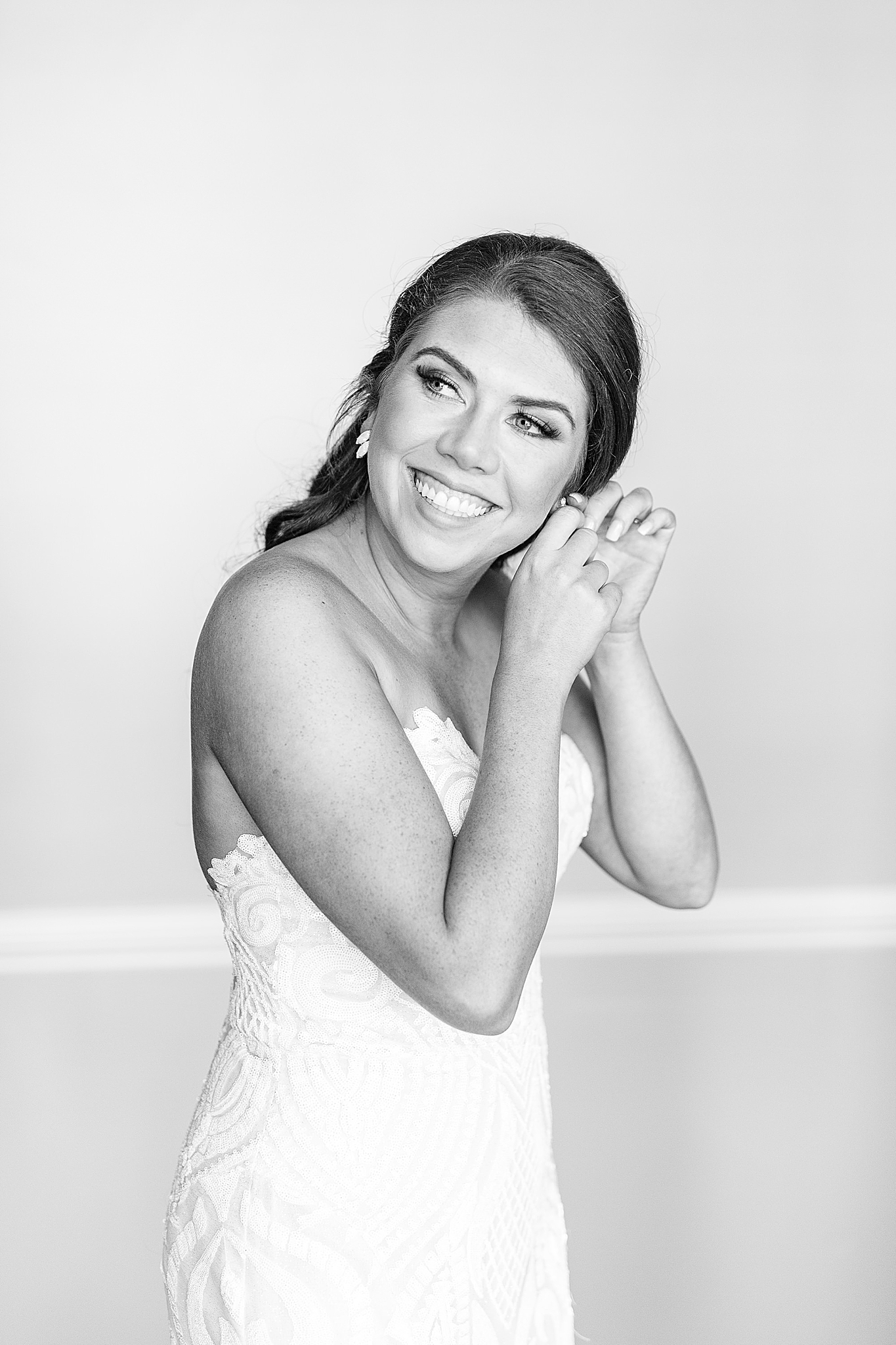 bride adjusts earrings before Charlotte NC wedding