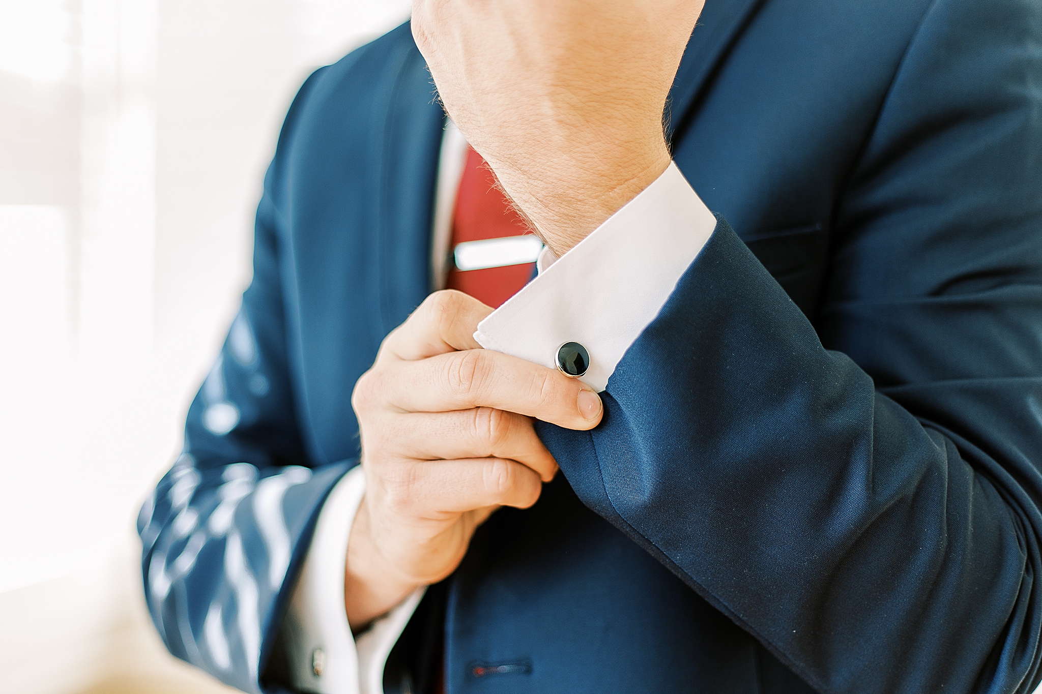 groom adjusts cufflinks before Separk Mansion wedding