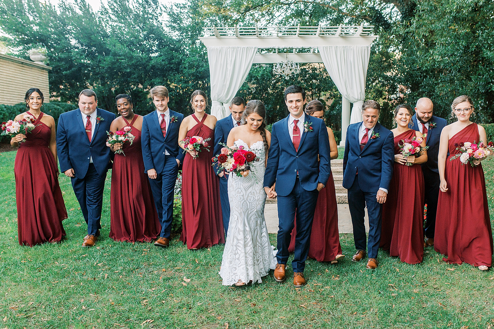 bride and groom walk with wedding party