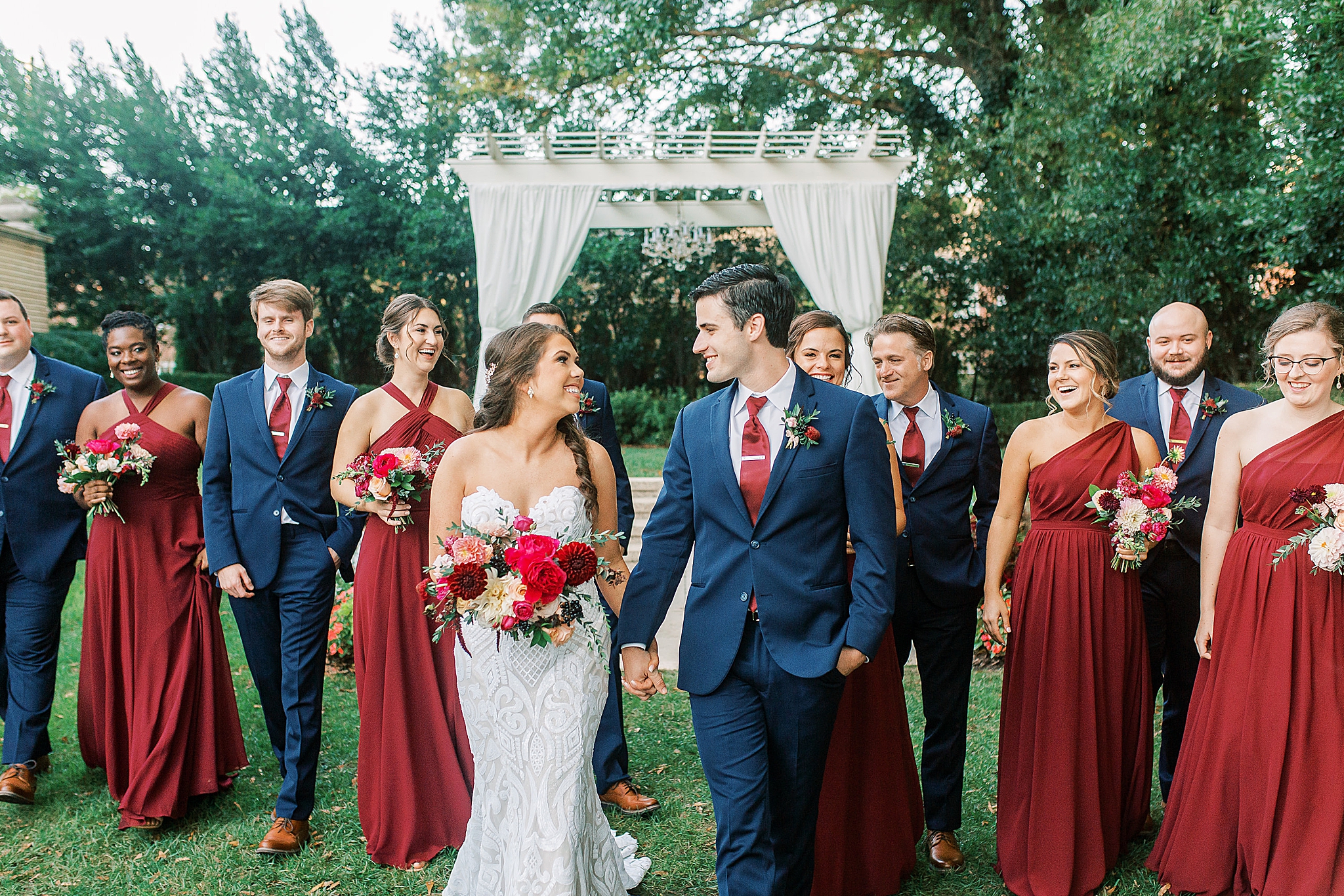 wedding party walks with bride and groom outside Separk Mansion