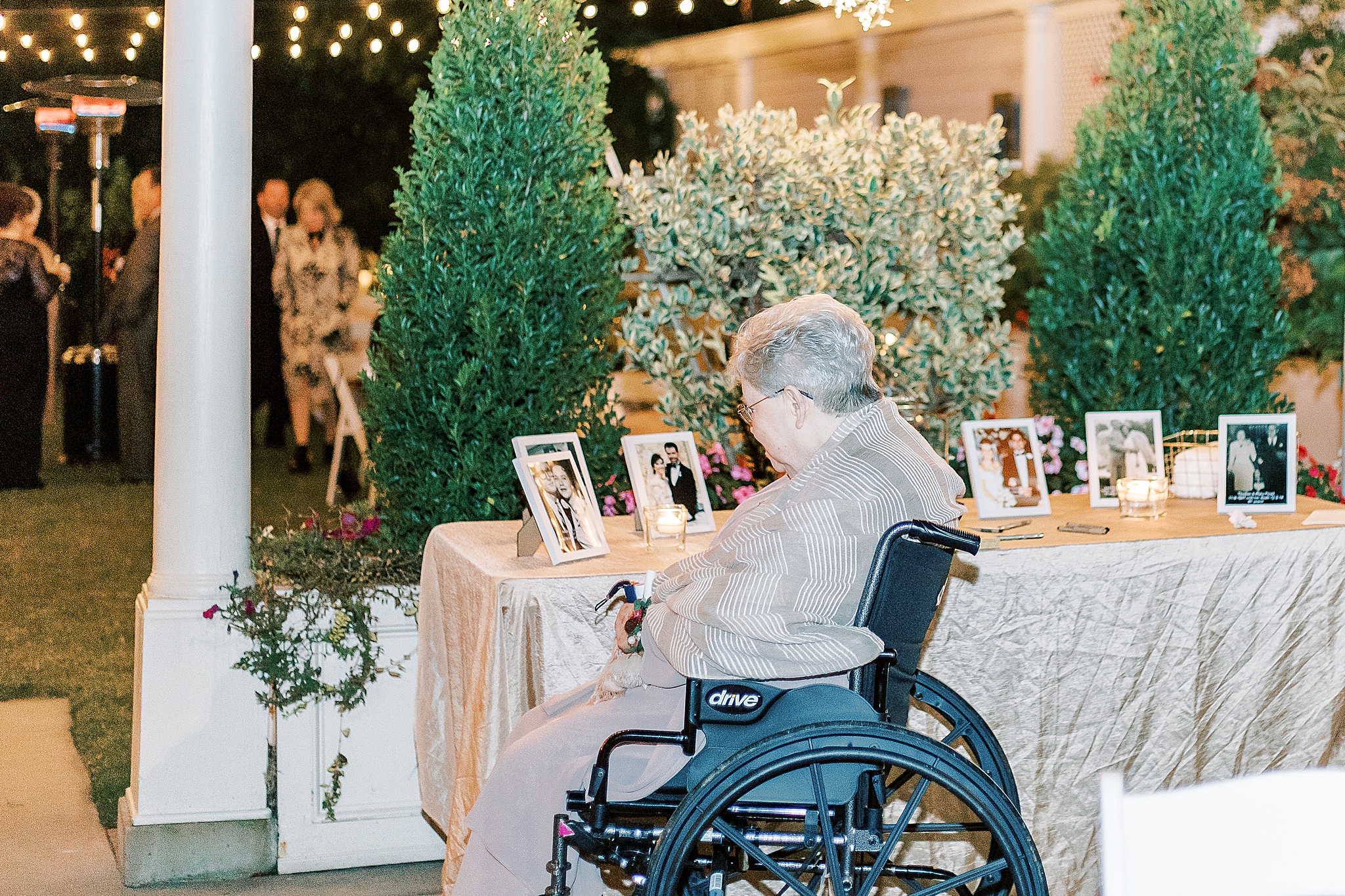 grandmother looks at portraits of husband