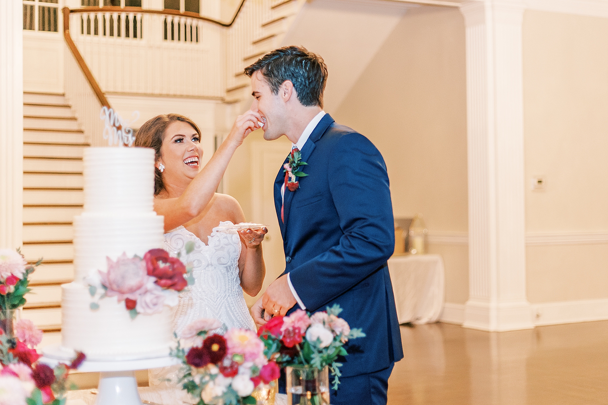 bride and groom cut wedding cake
