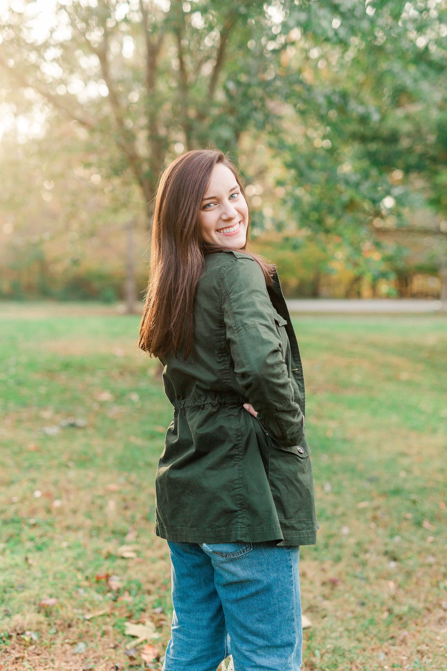 senior puts hand on hip during portraits at Sloan Park