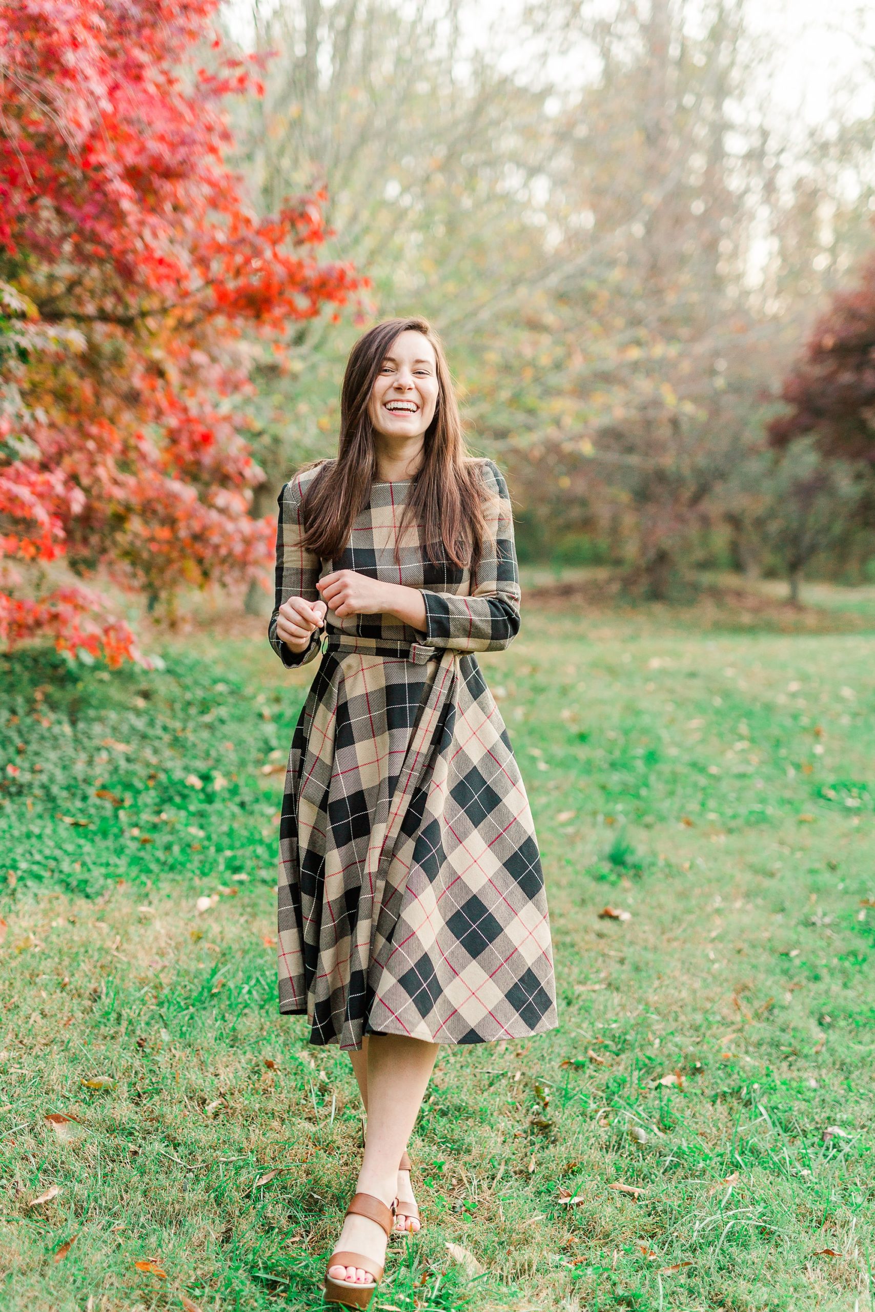 senior laughs with photographer at Sloan Park