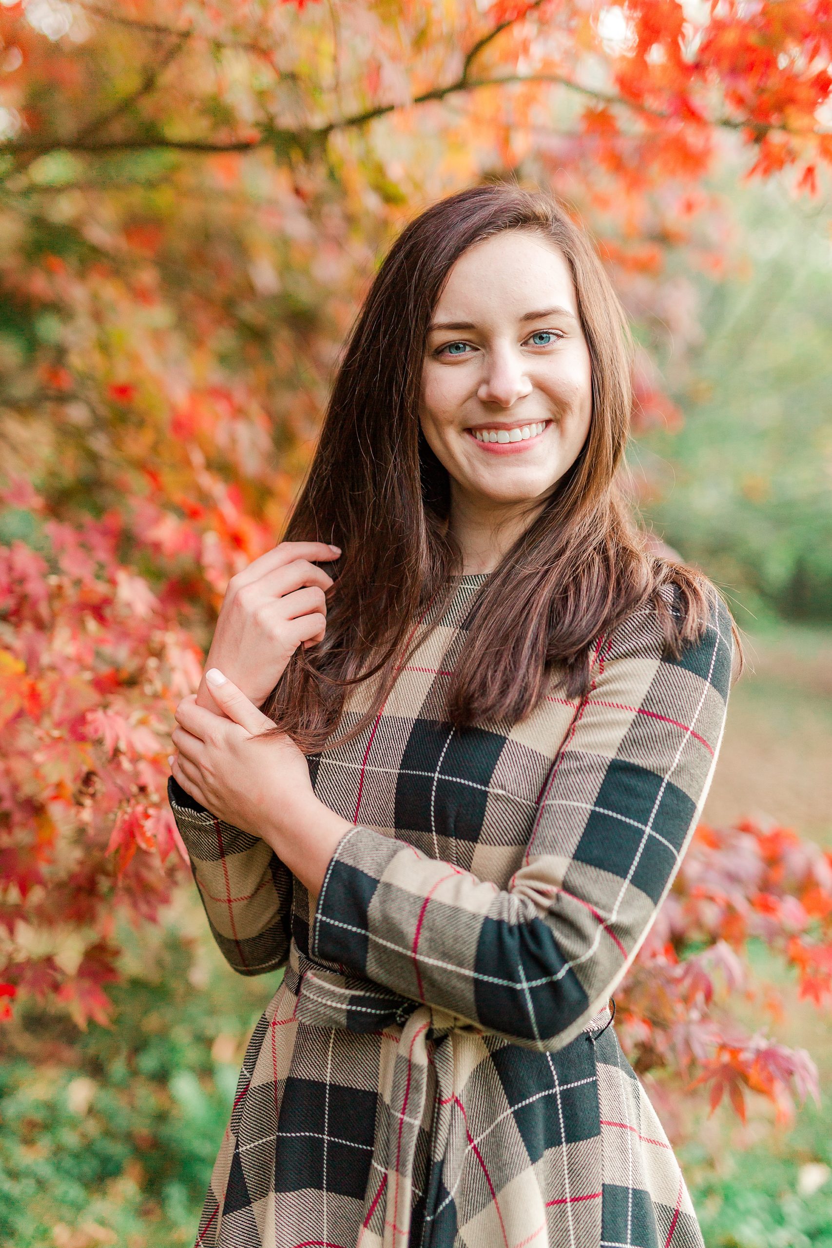 senior portraits at Sloan Park by fall trees