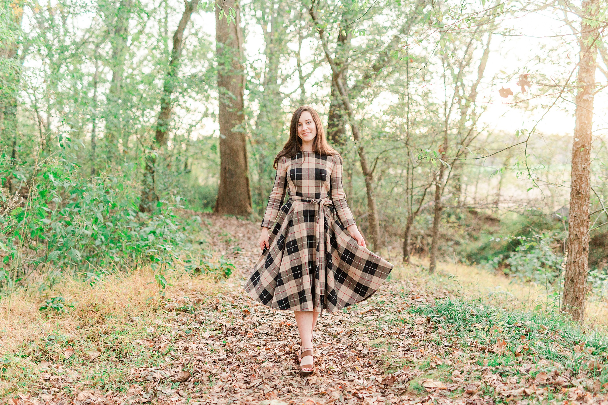 senior walks through leaves at Sloan Park