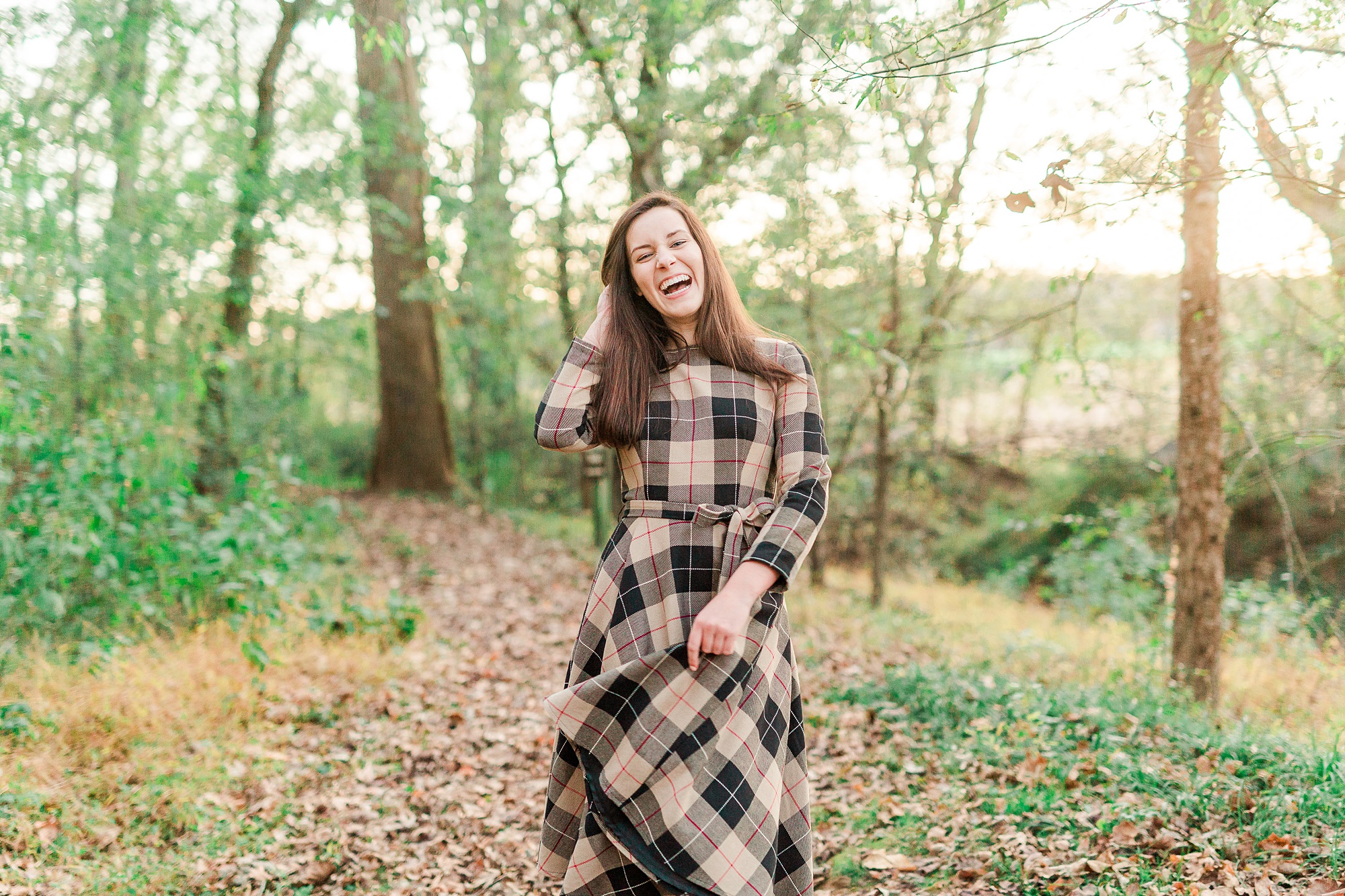 senior laughs during fall senior photos at Sloan Park