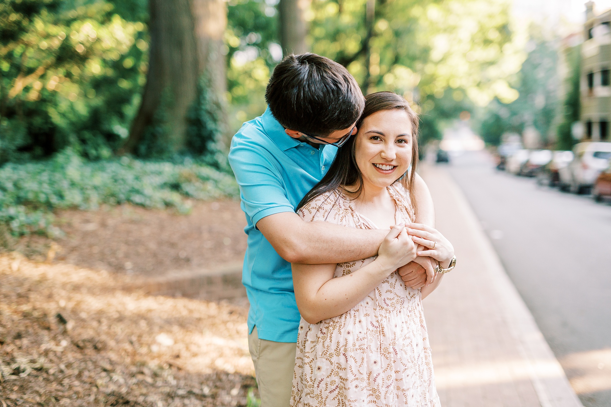 groom kisses bride's cheek during Fourth Ward Park engagement session