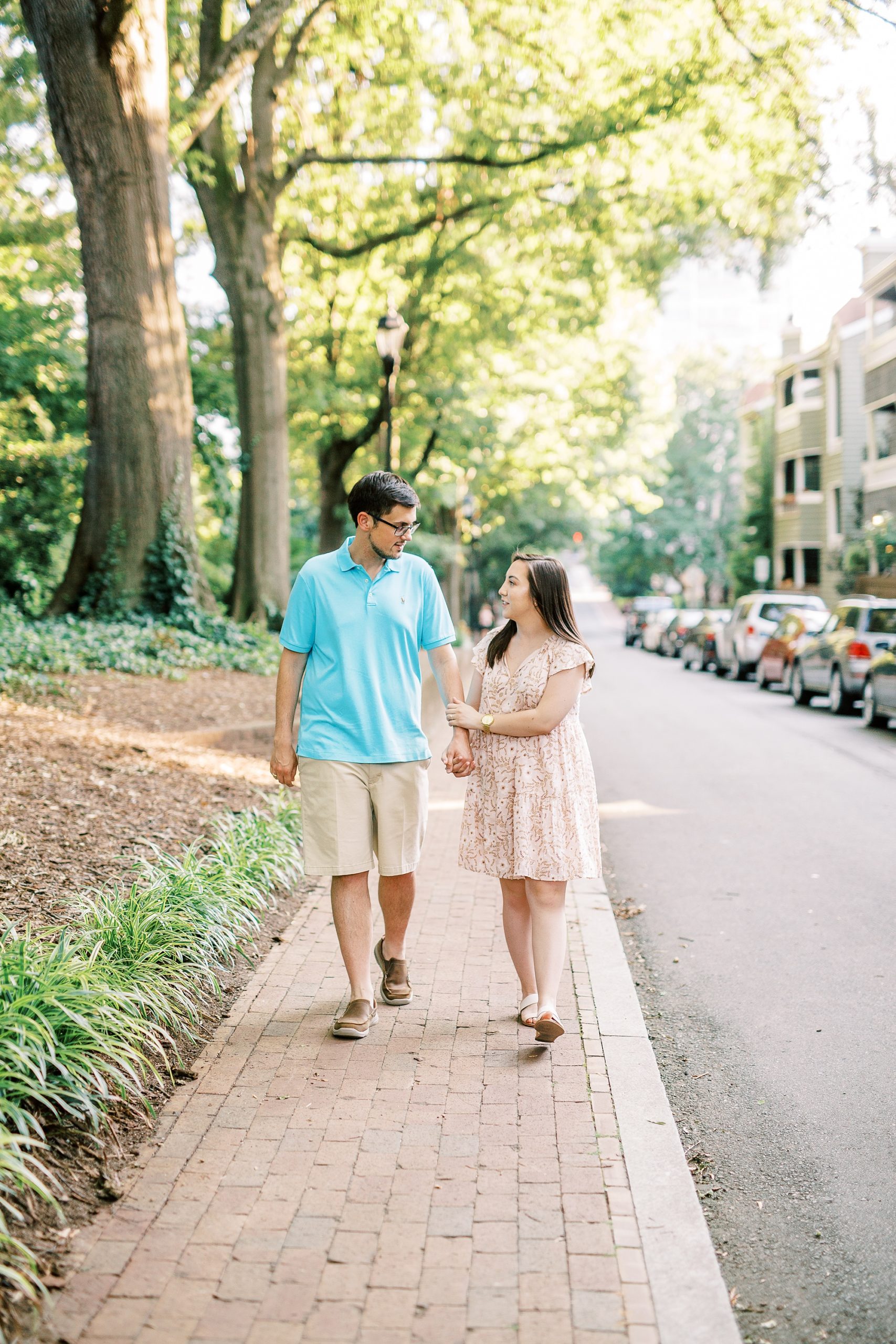 bride and groom walk down sidewalk in Fourth Ward Park