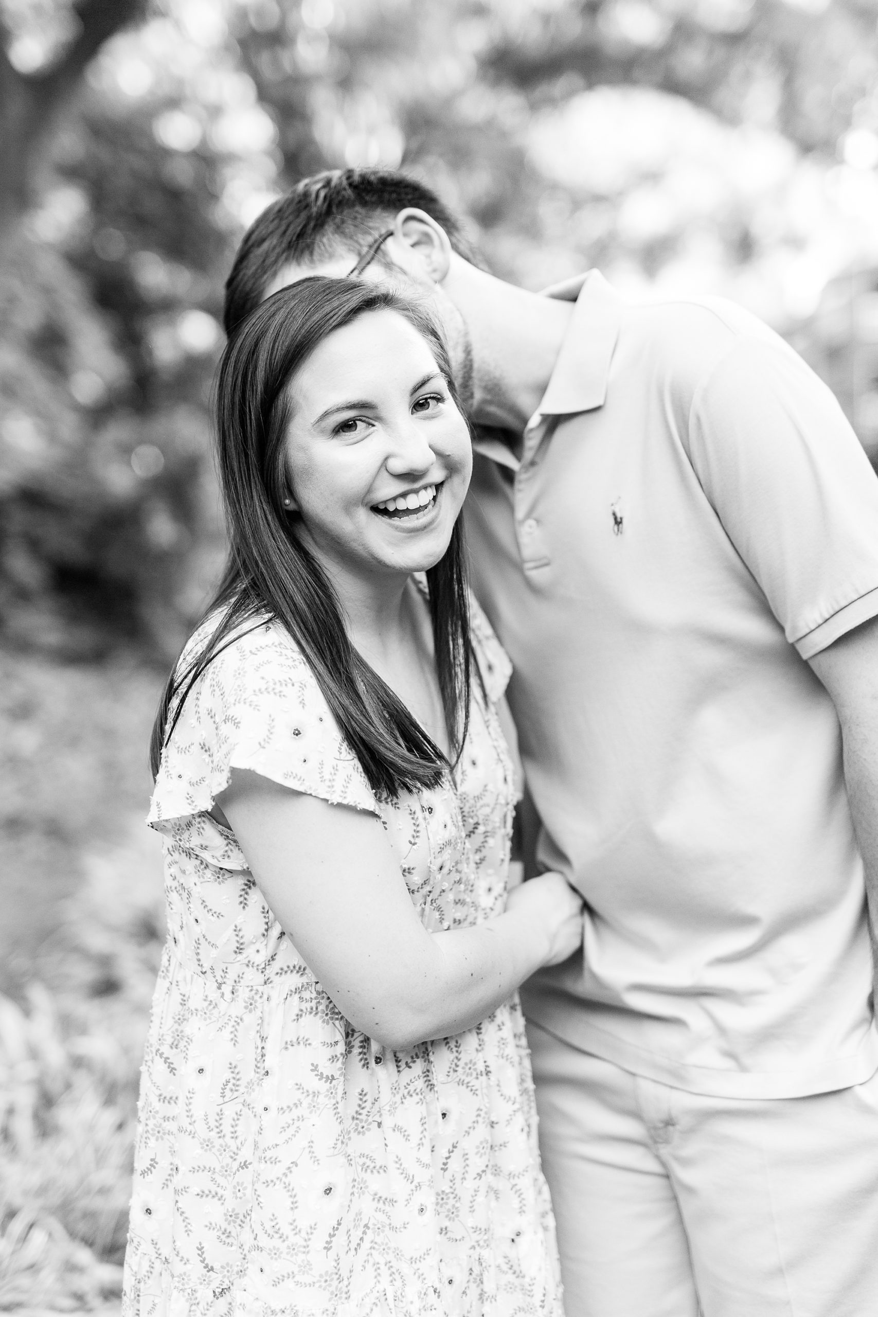 groom kisses bride's cheek during Fourth Ward Park engagement photos
