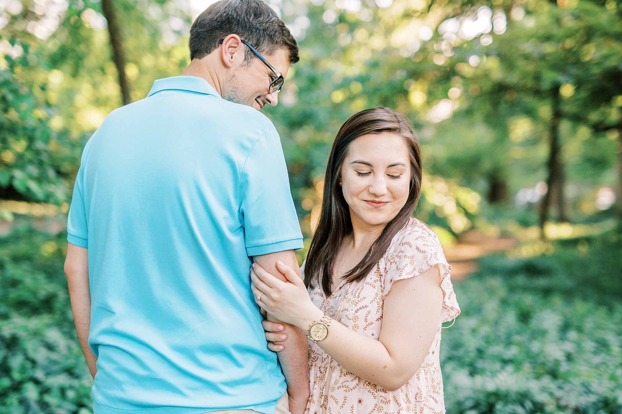 bride looks over shoulder during engagement photos