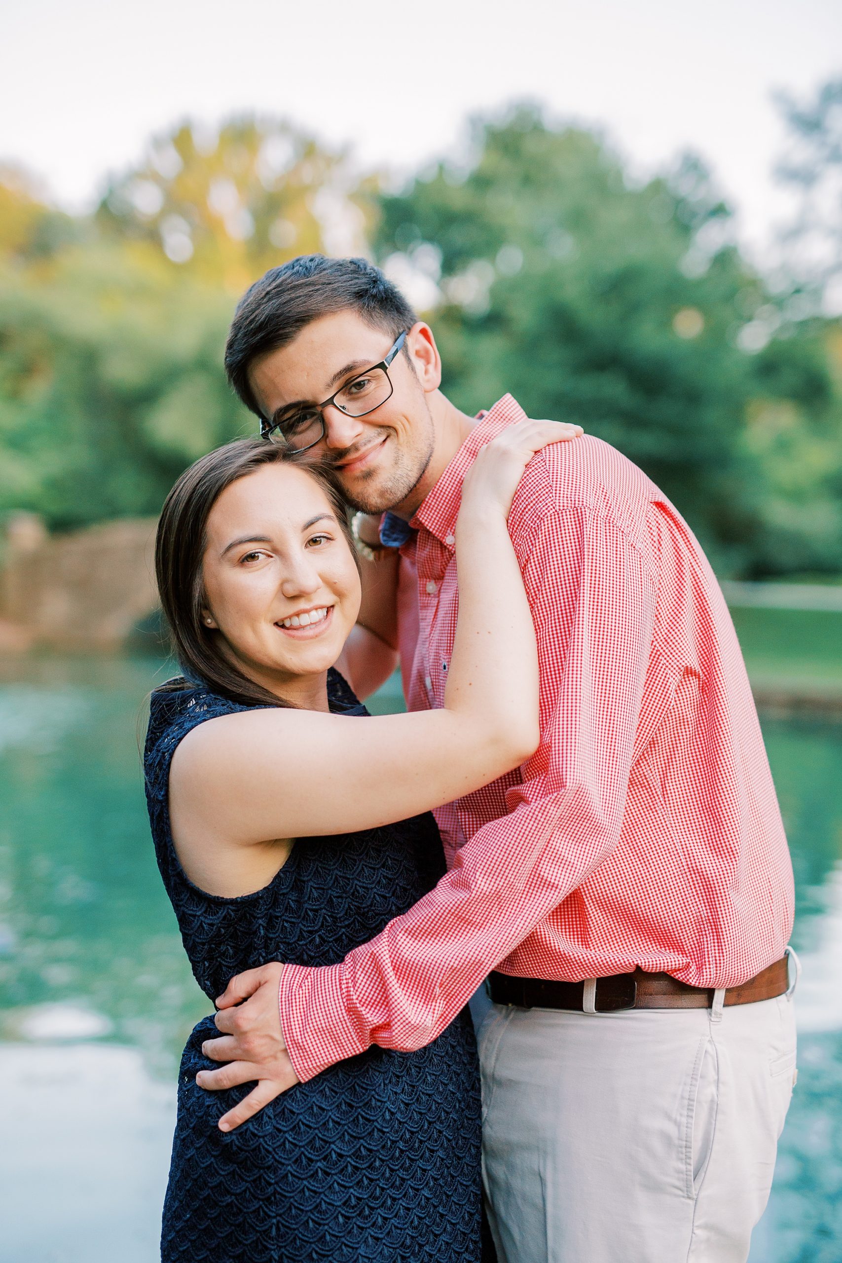 bride and groom stand cheek to cheek during Freedom Park engagement photos