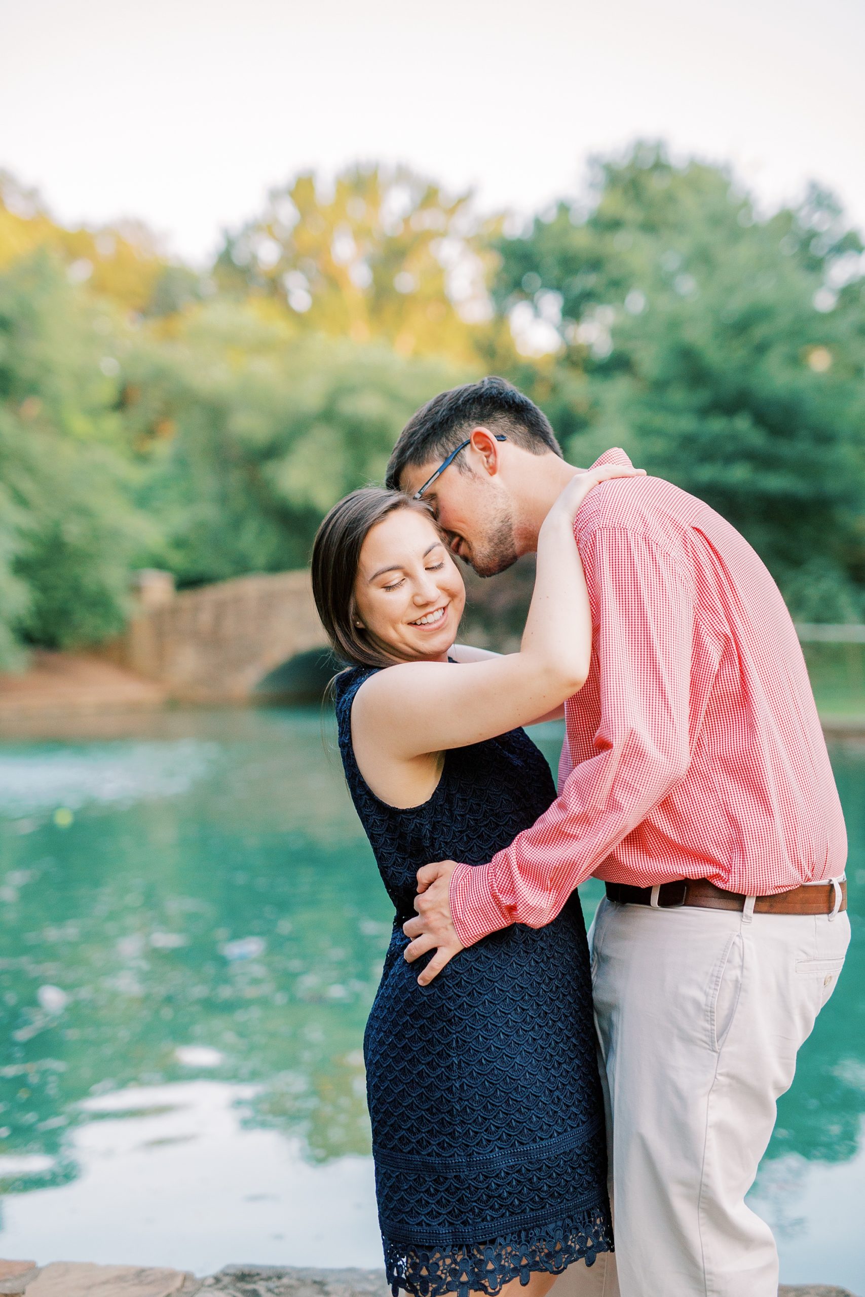 groom kisses bride's forehead during Freedom Park engagement photos