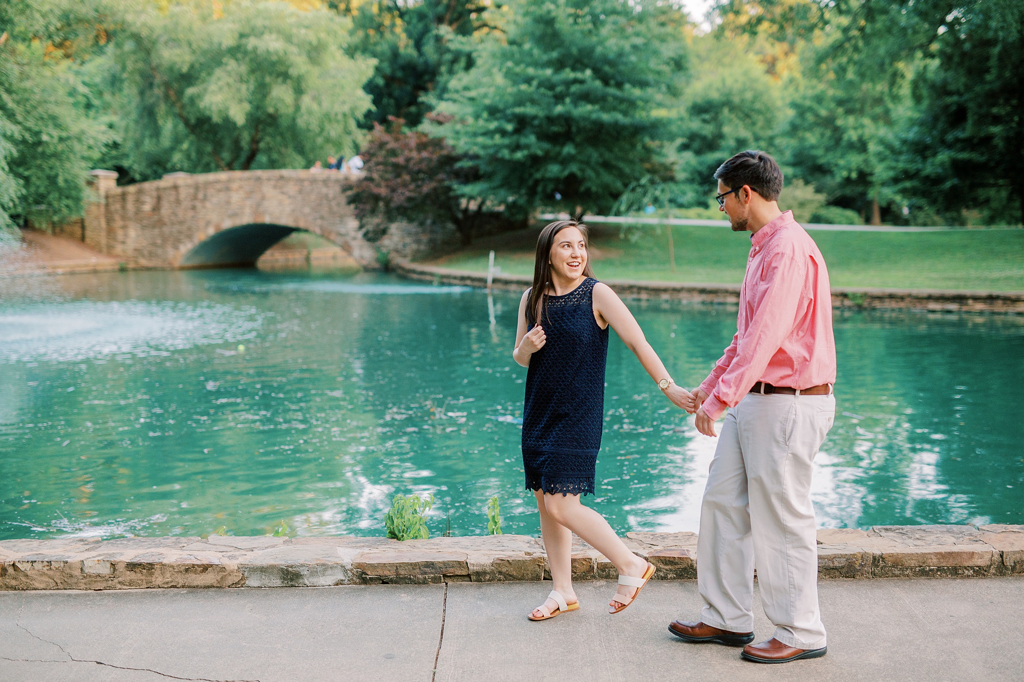 couple walks along pond in Freedom Park