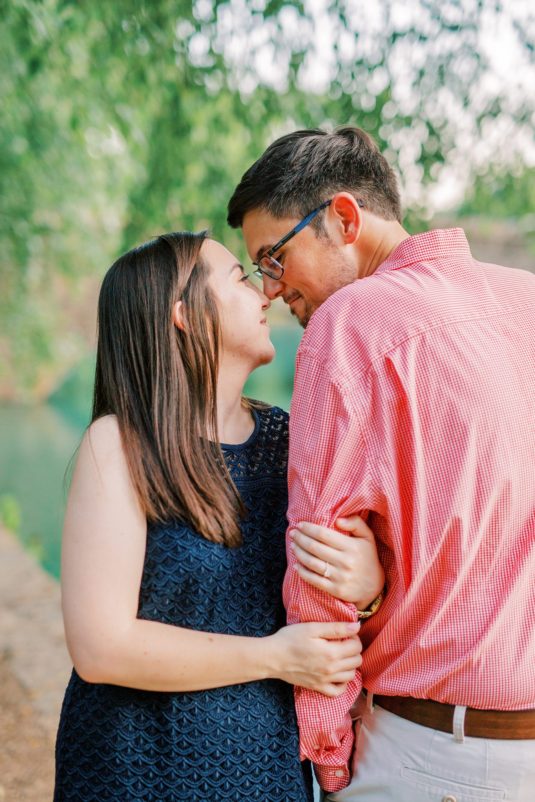 bride and groom pose under willow tree at Freedom Park