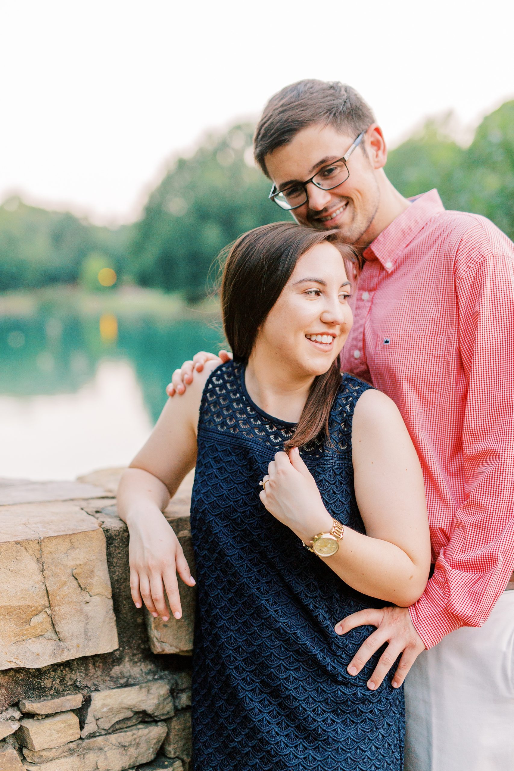 bride and groom pose on brick bridge in Freedom Park