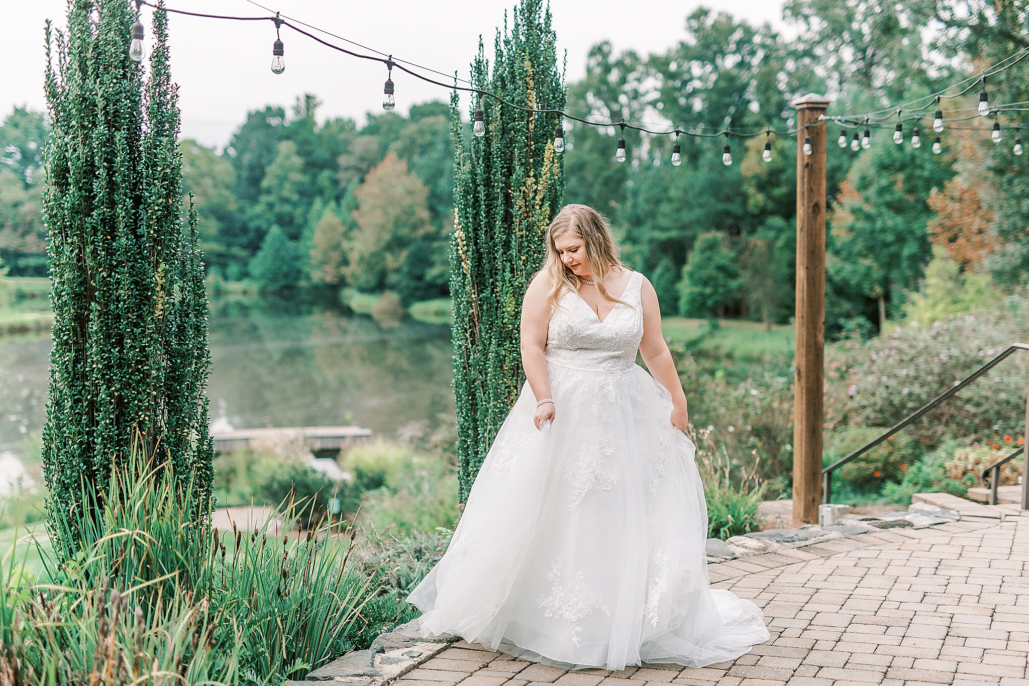 bride dances under string lights in Cleveland NC