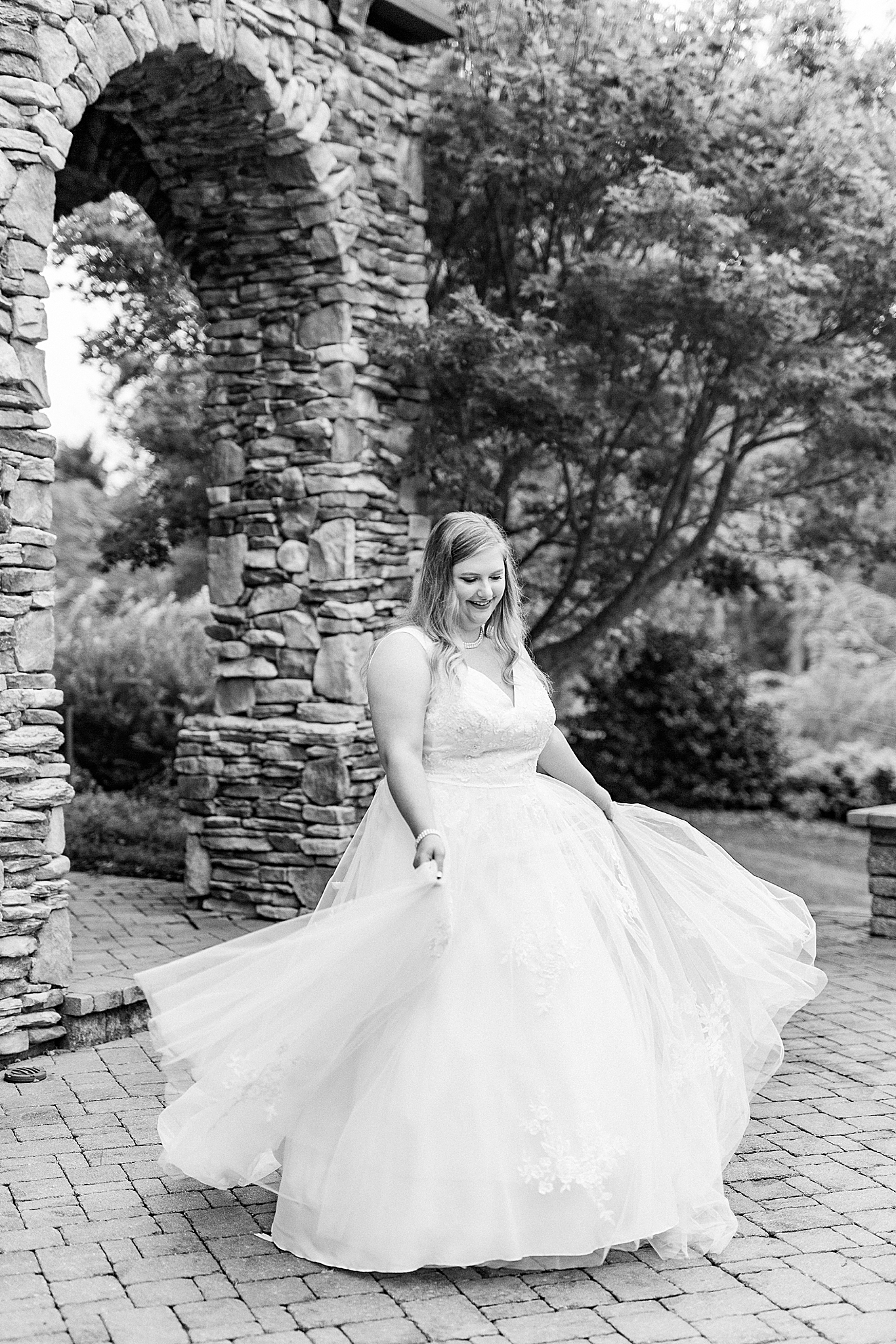 bride spins wedding gown during The Arbors Bridal Portraits