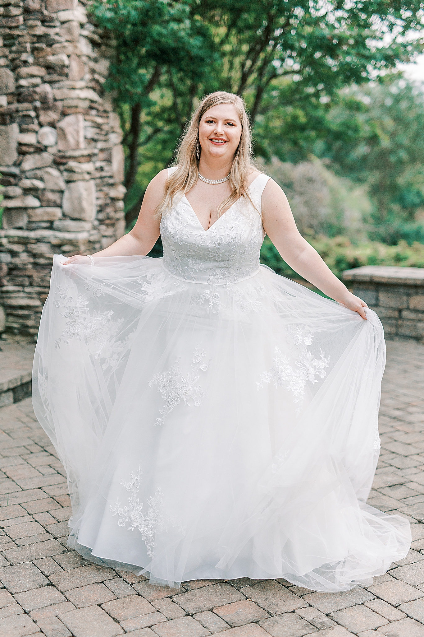 bride shows off classic wedding gown