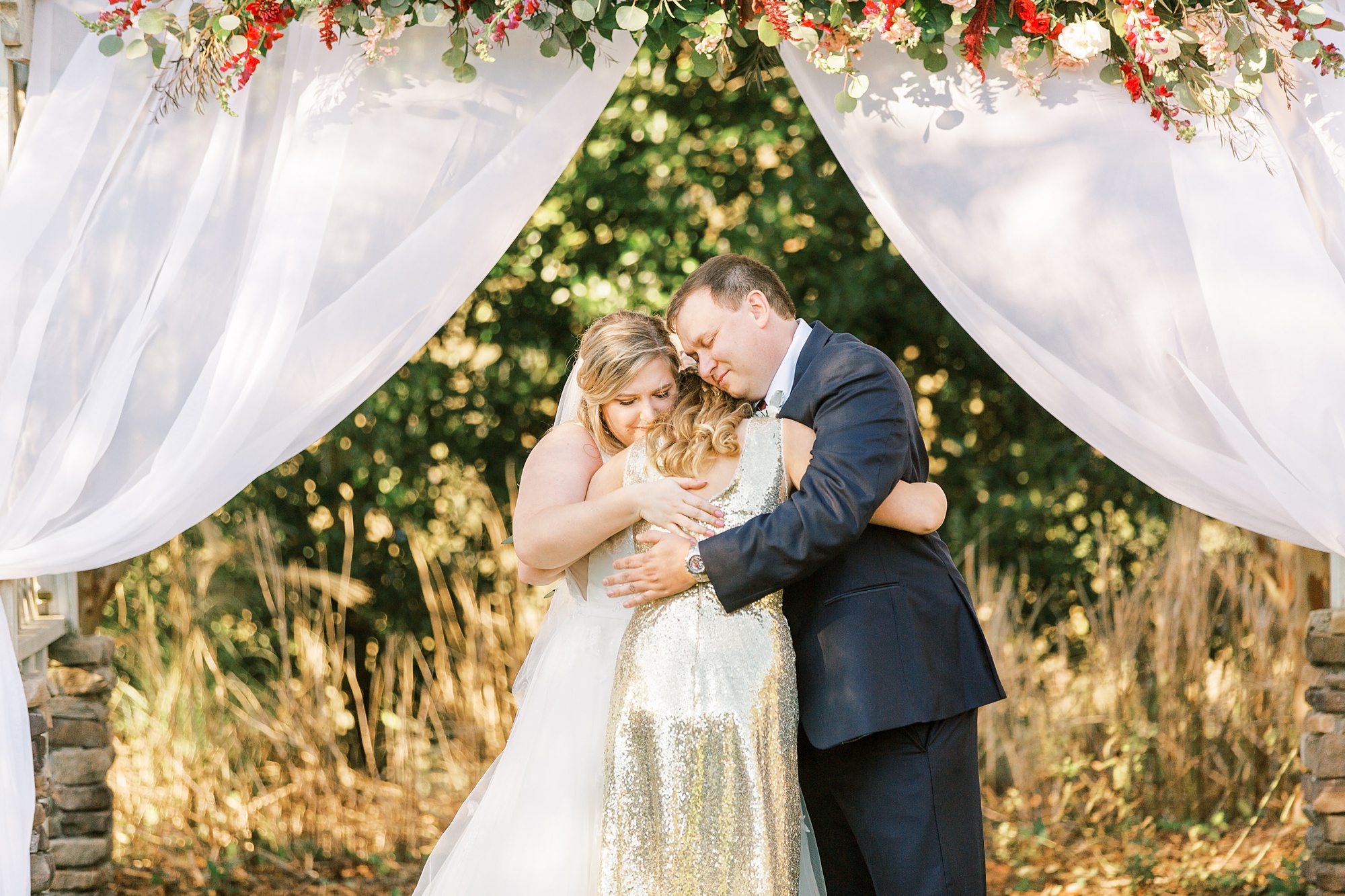 family hugs during Arbors Events wedding ceremony