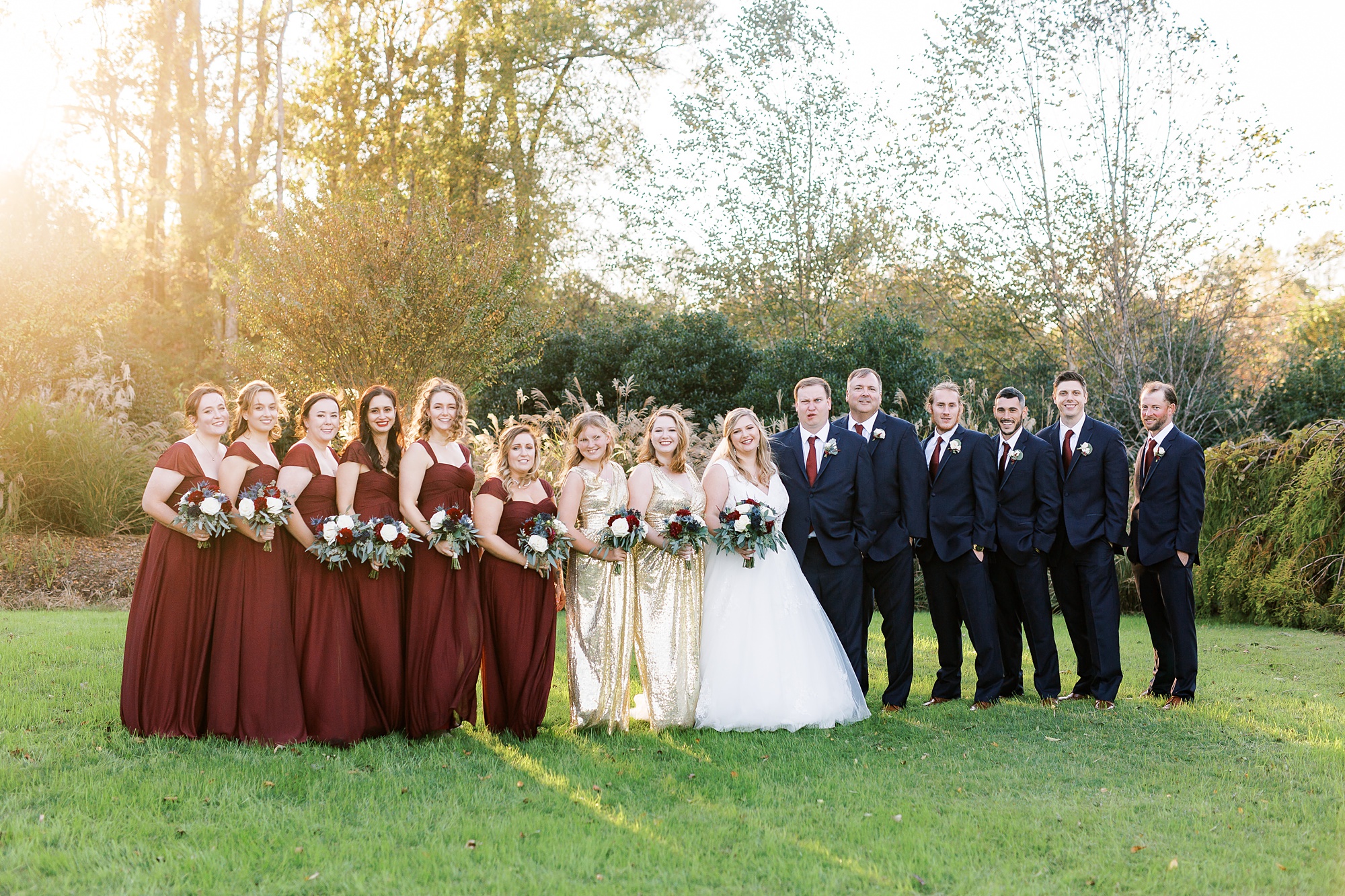 bride and groom pose with bridesmaids and groomsmen