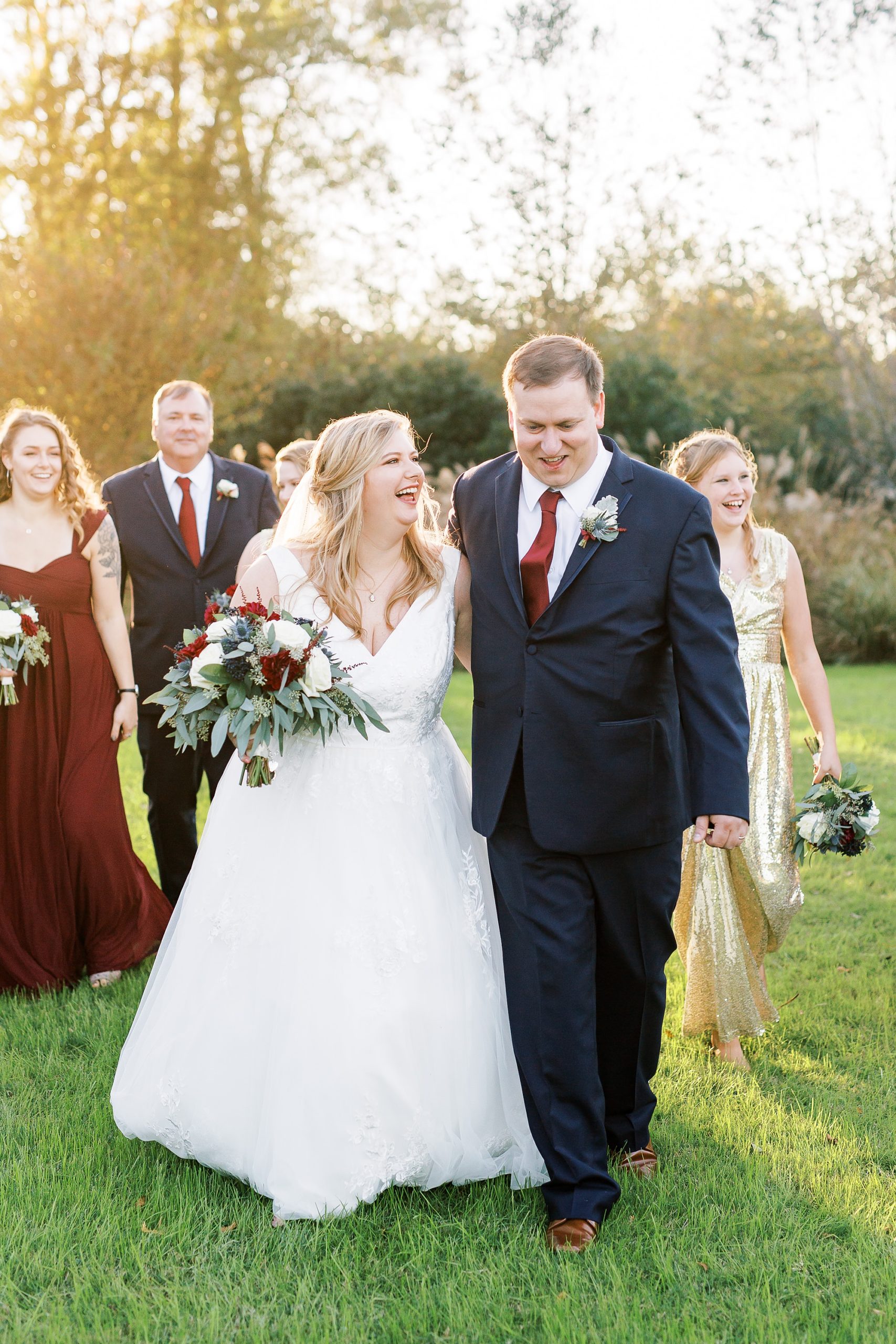 bride and groom laugh with wedding party at Arbors Events