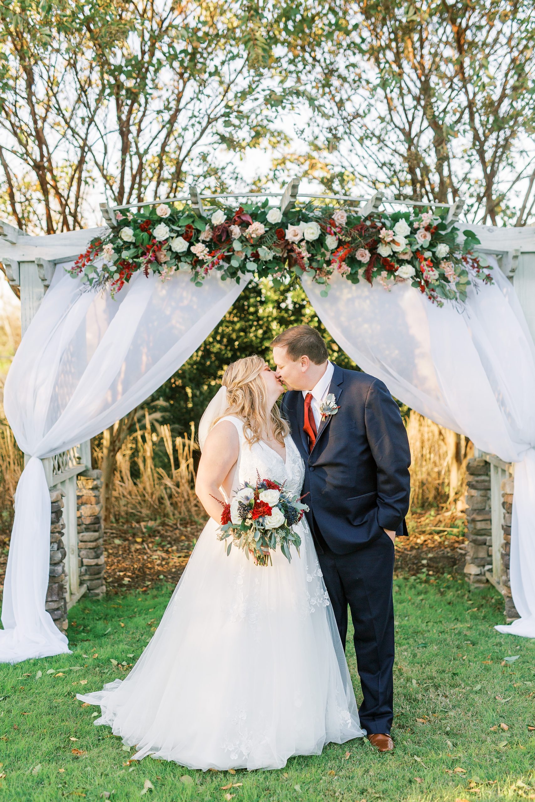 the Arbors Events wedding portraits under floral arbor