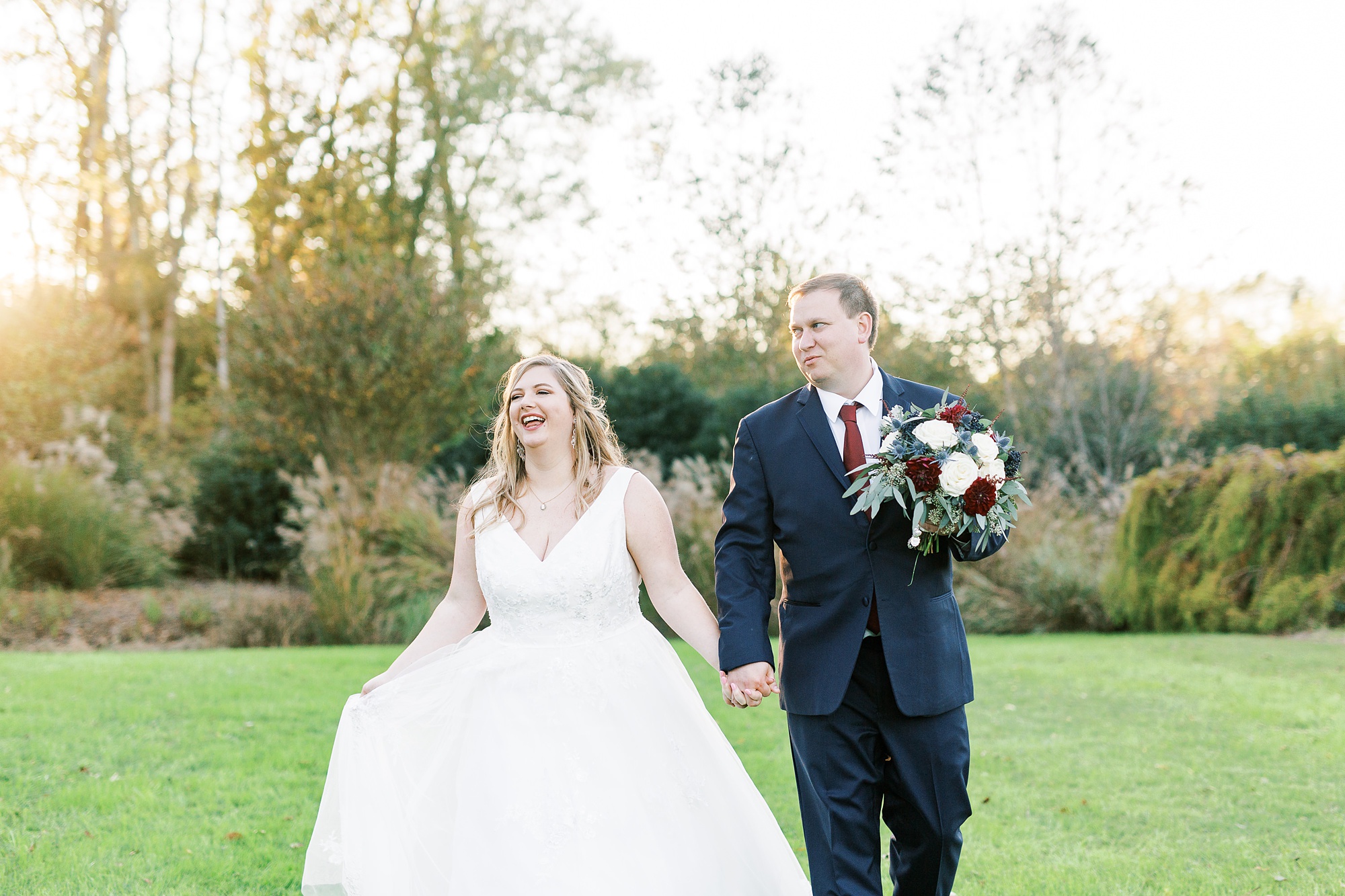 groom makes bride laugh during wedding photos at the Arbors Events
