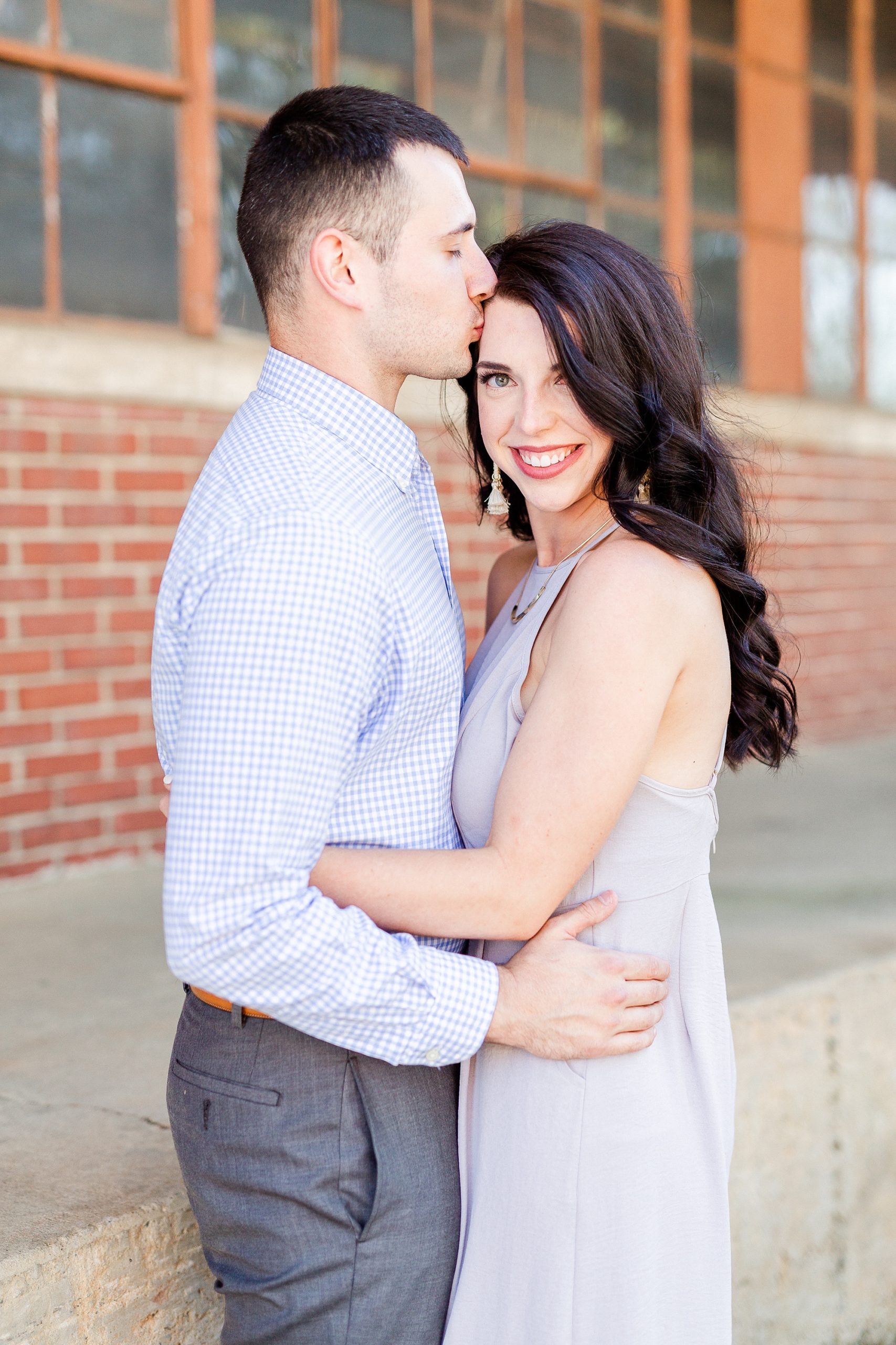 groom kisses bride's forehead during NC engagement photos