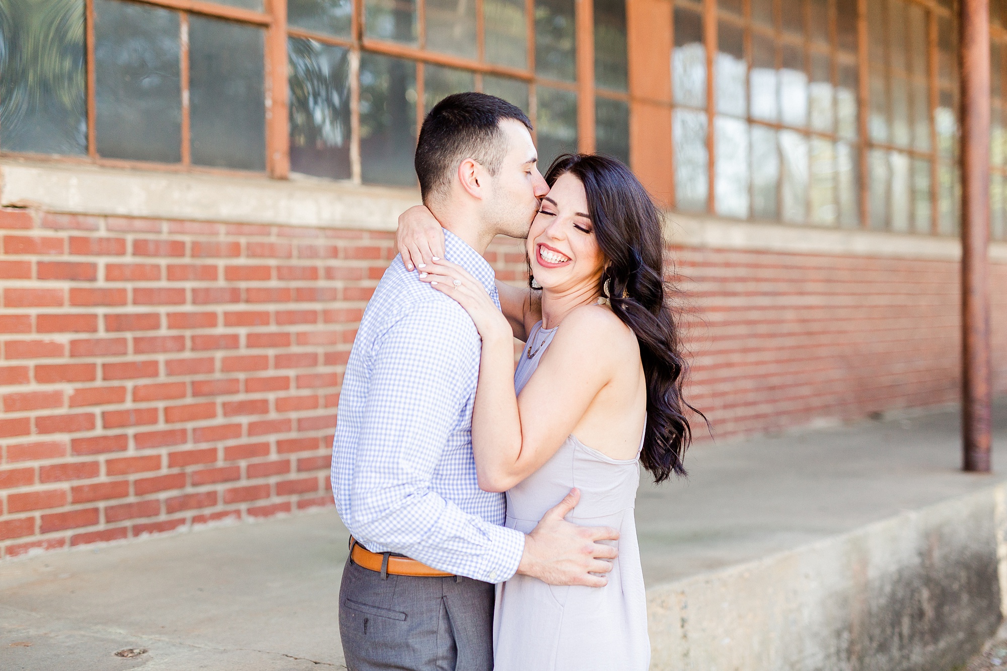 bride and groom pose in alley at Camp North End