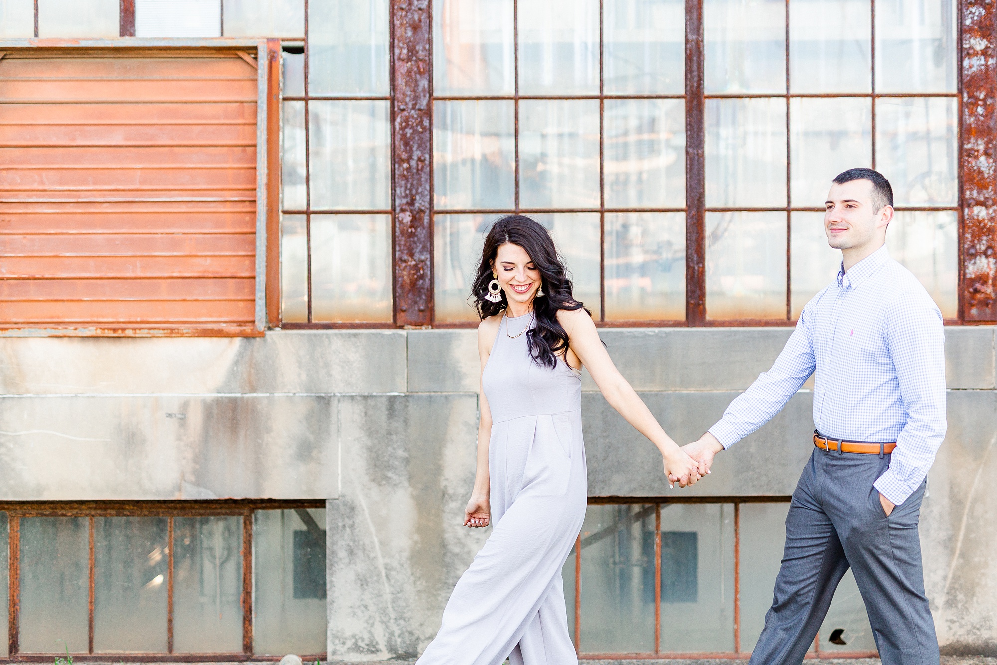 engaged couple holds hands and walks in North Carolina