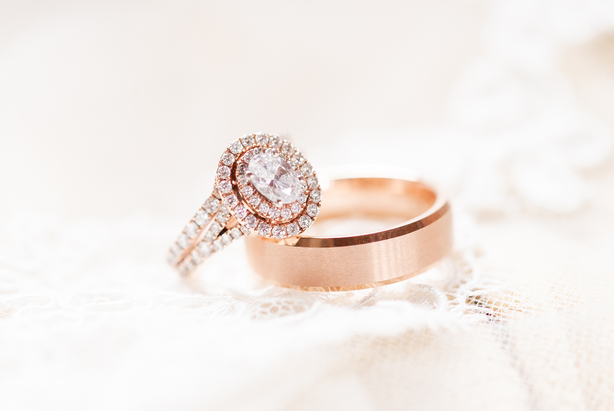rose gold wedding bands rest on veil