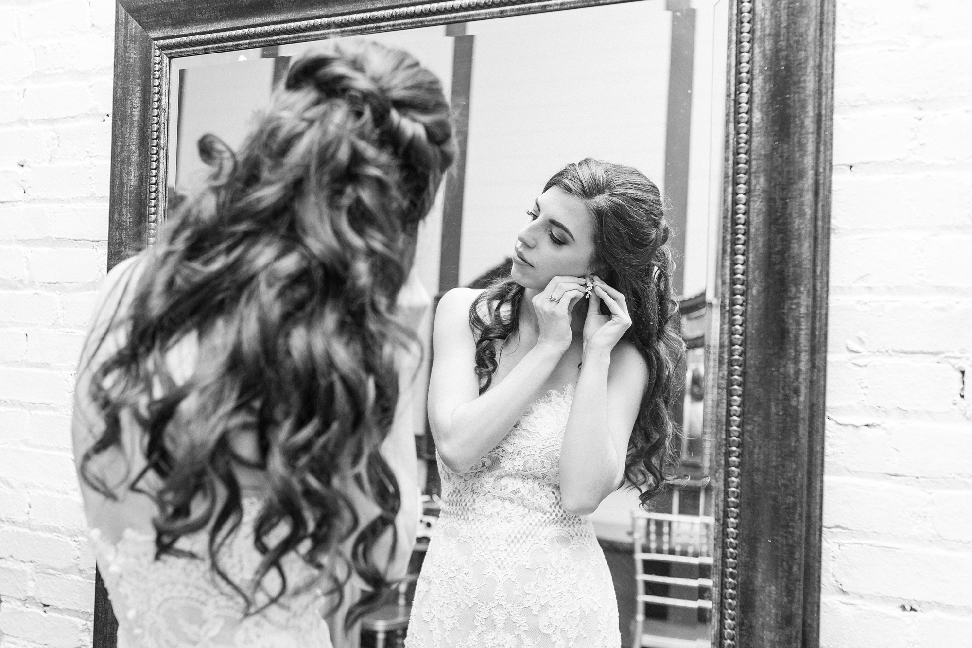 bride adjusts earrings before first look