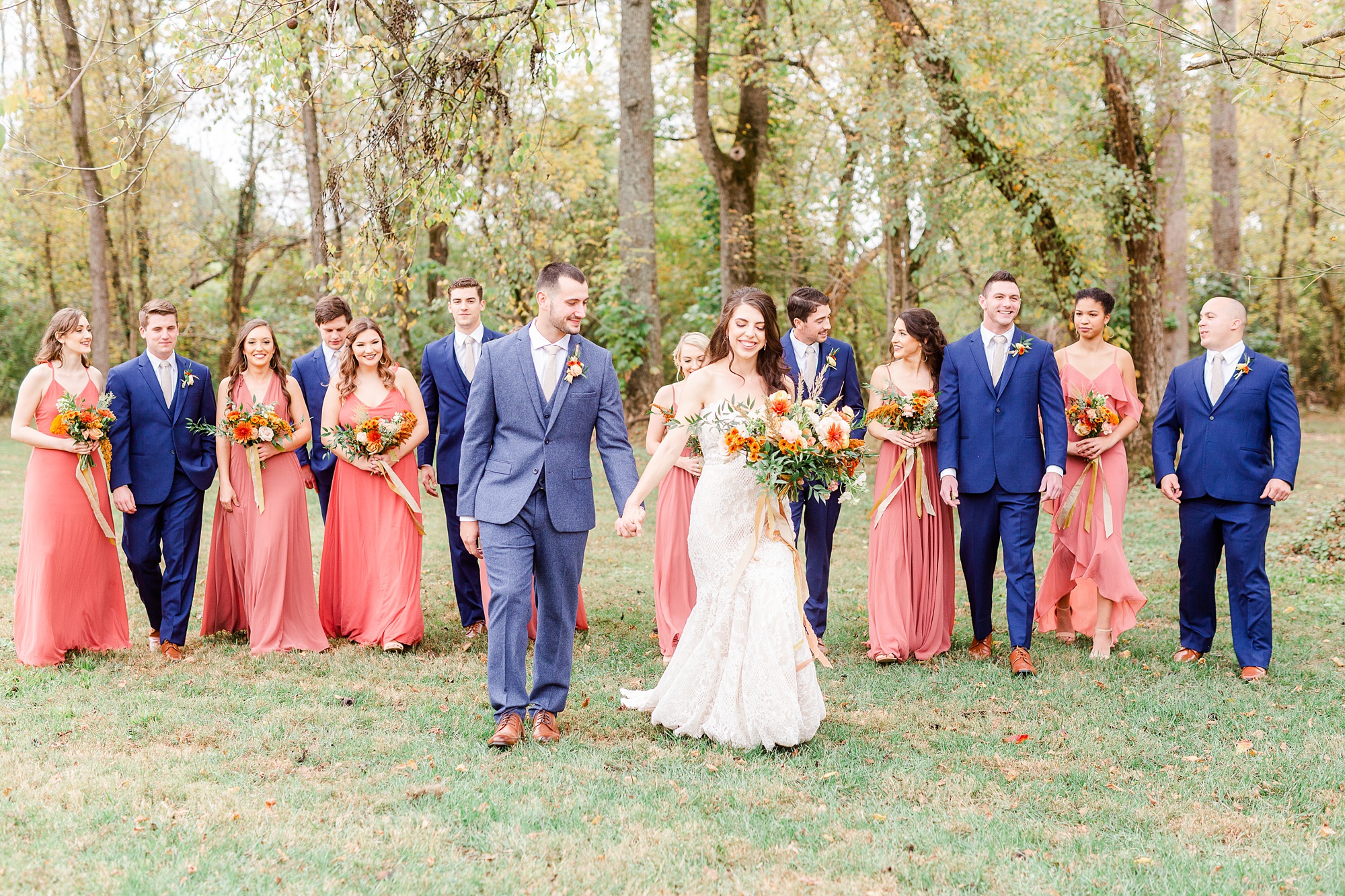 newlyweds walk with bridal party at Providence Cotton Mill
